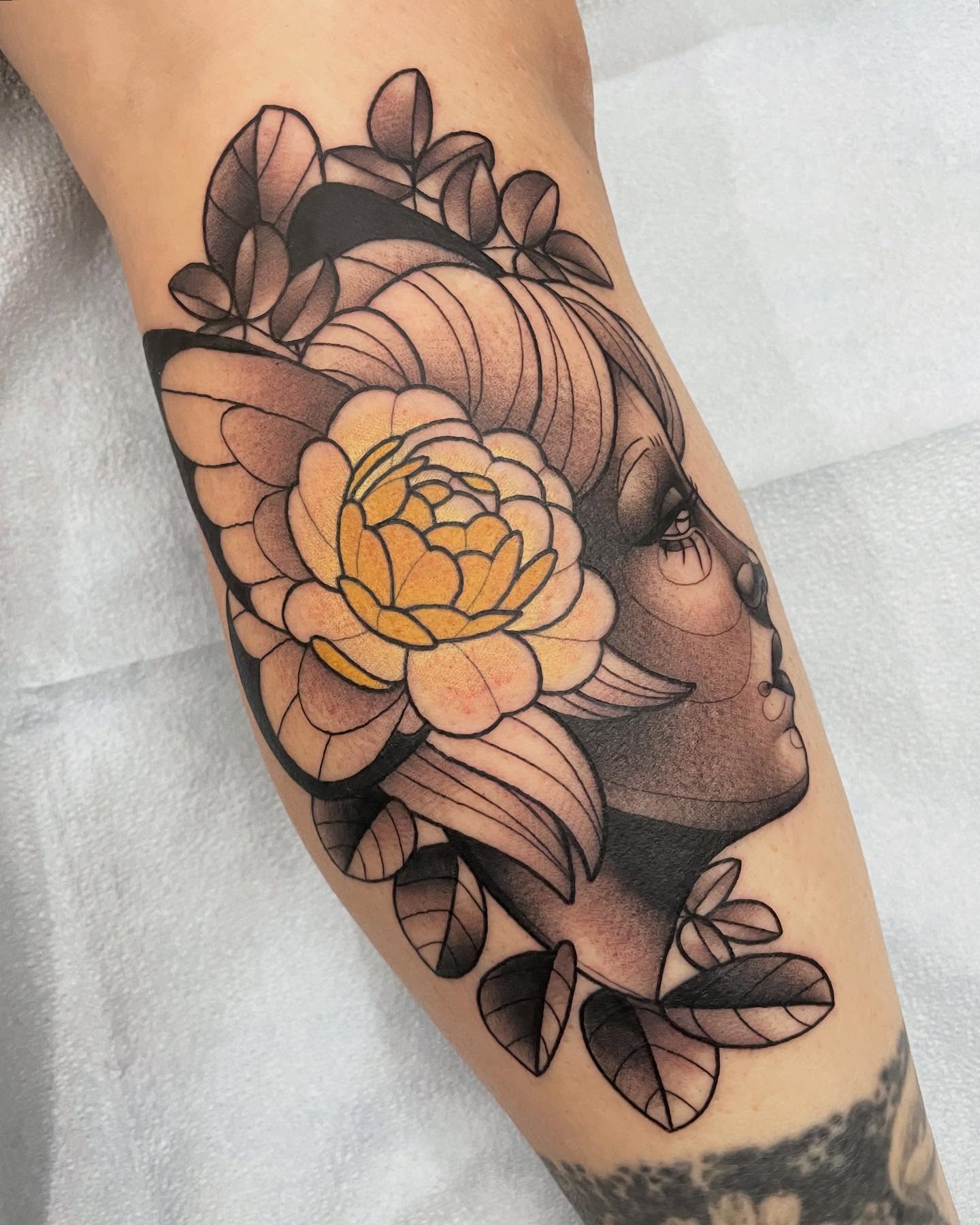 Flower and woman's face black and grey tattoo on the forearm by Amy Jean, Minneapolis, Minnesota