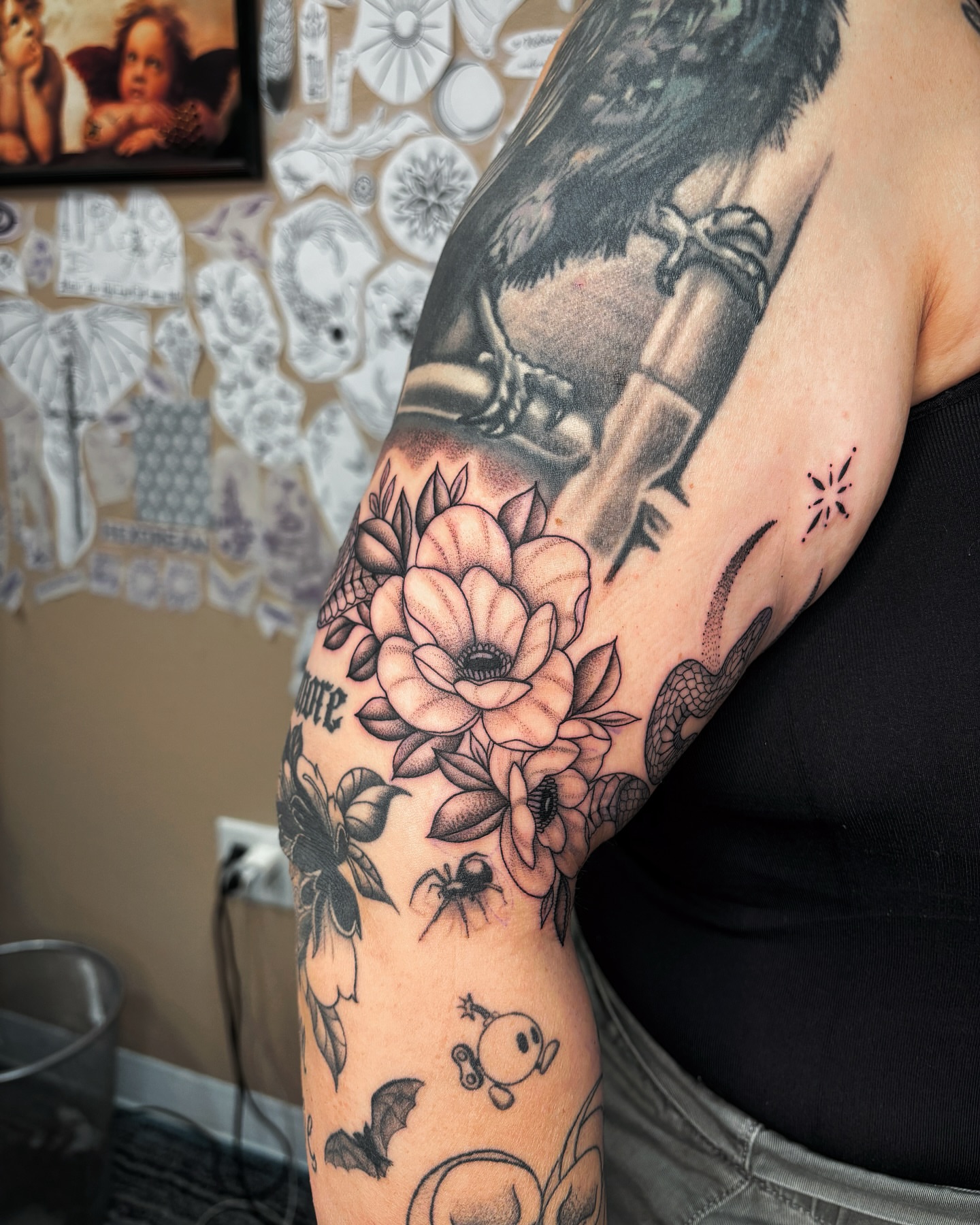 Flower and crow American traditional tattoo on the forearm by Alexandria Gudiel