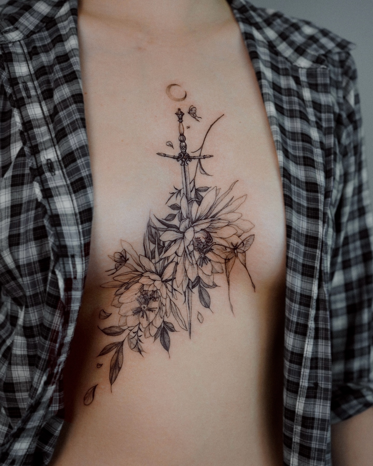 Flower and sword fine line tattoo on the ribs by Yeonji