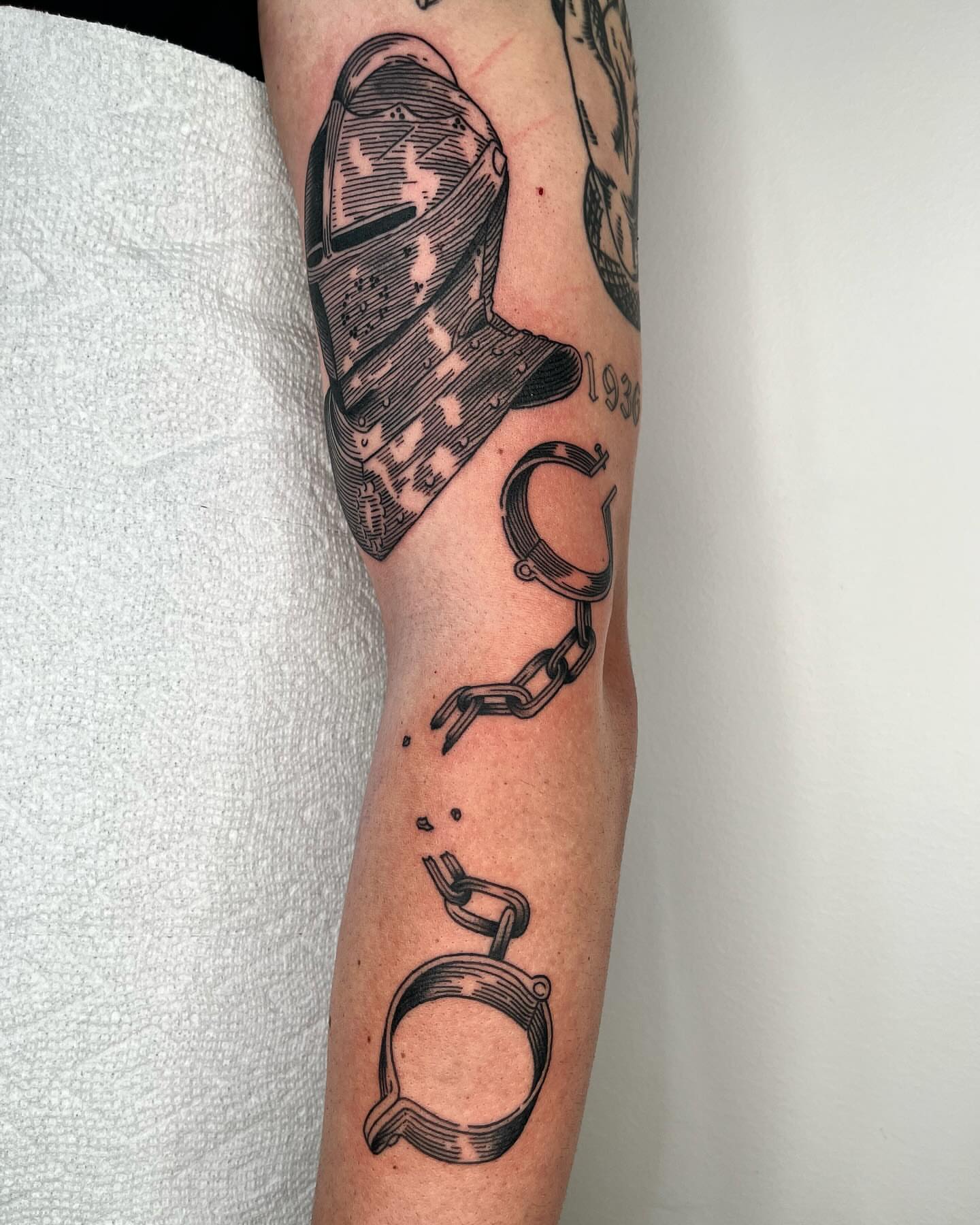Handcuffs black and grey tattoo on the forearm by zach arlan, Kansas City, Missouri