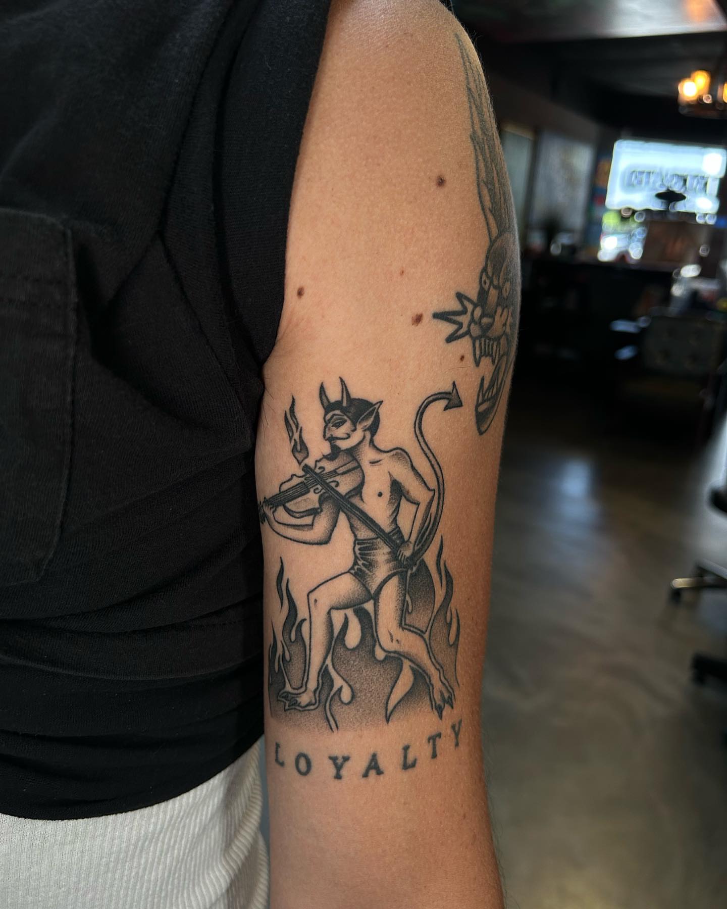 Demon with sword black and grey tattoo on the forearm by Lexi Kniskern