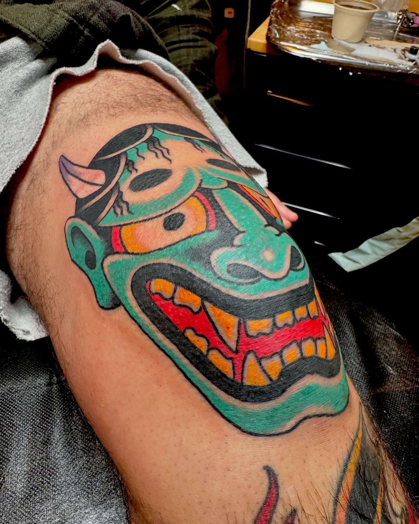 Mask American traditional tattoo on the thigh by Nick Rodin