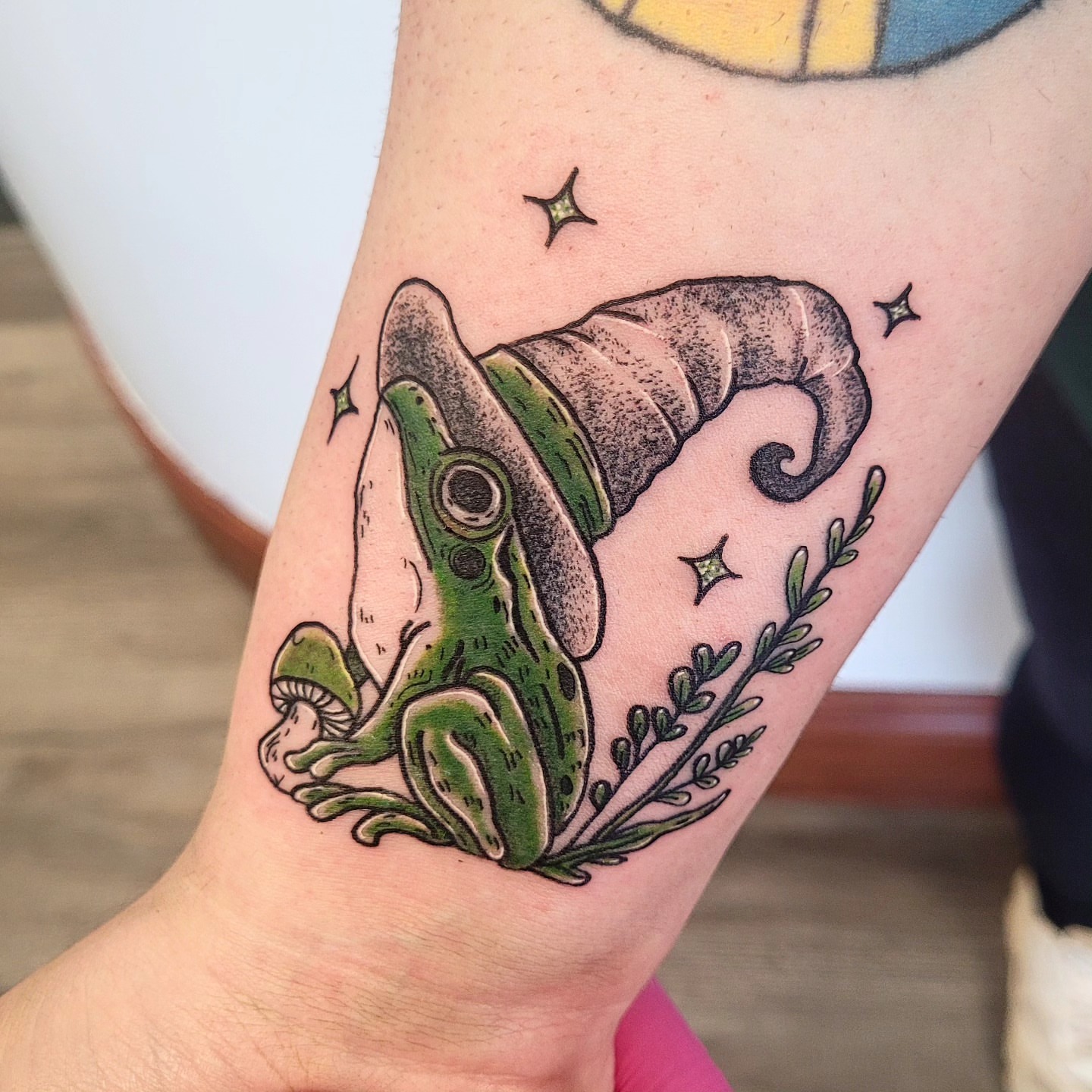 Frog with wizard hat dotwork tattoo on the forearm by Wray Saulsberry
