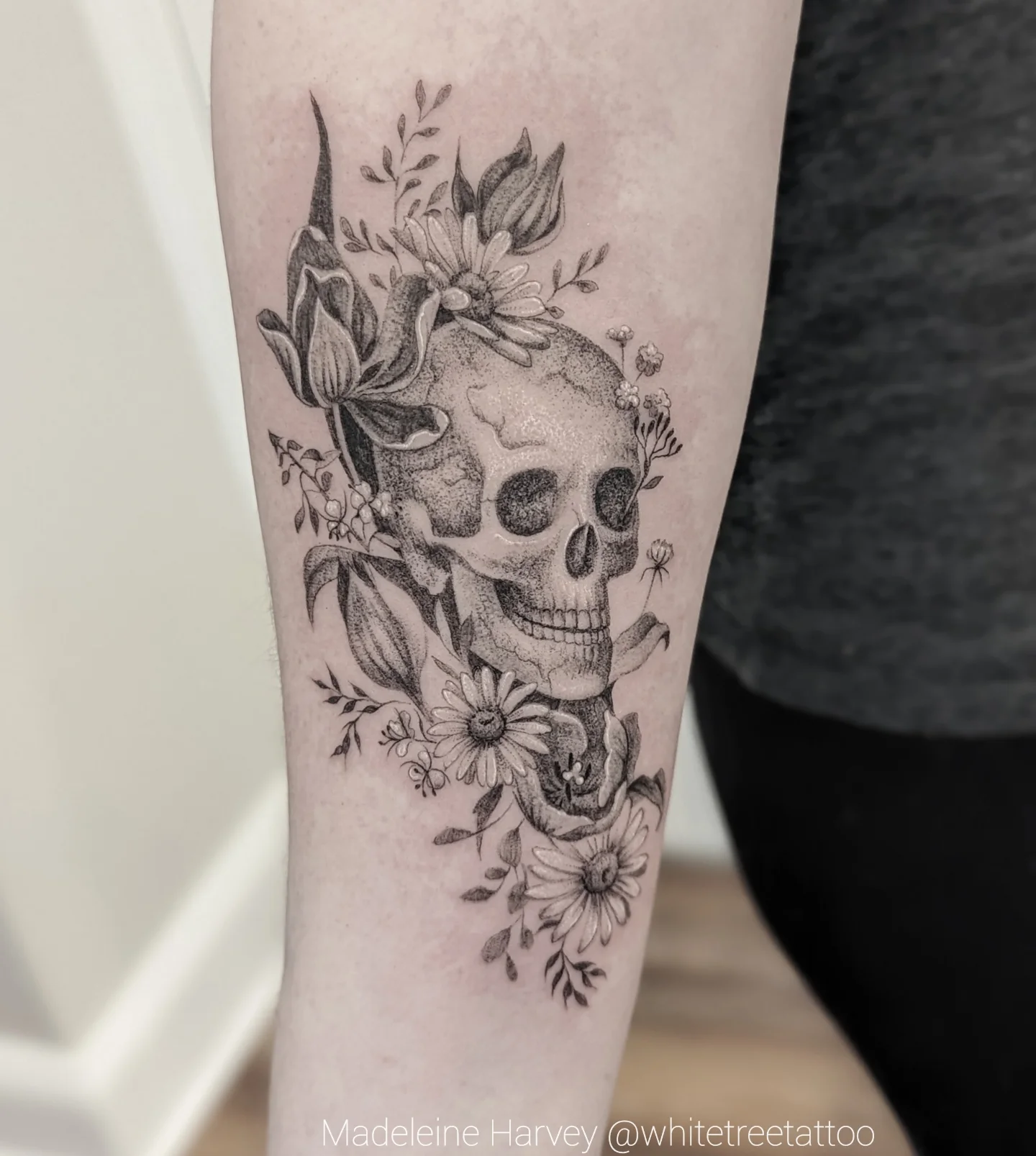 Skull with floral crown dotwork tattoo on the forearm by Maddie