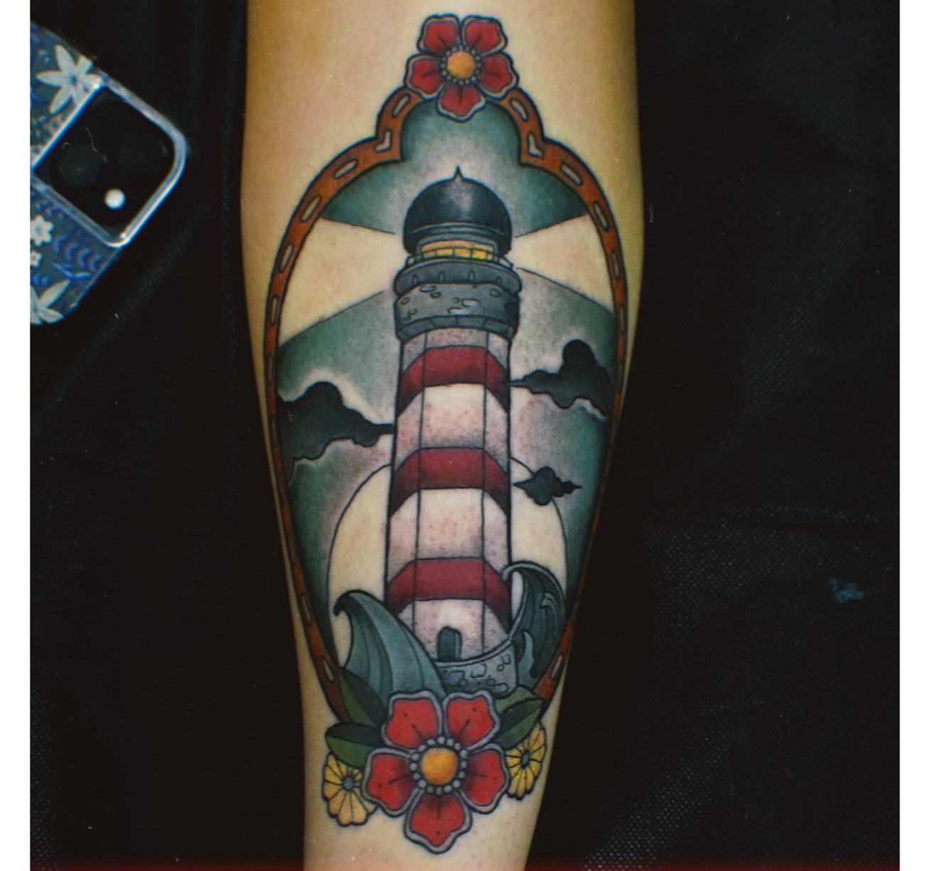 Lighthouse American traditional tattoo on the forearm by Jamie Clinton