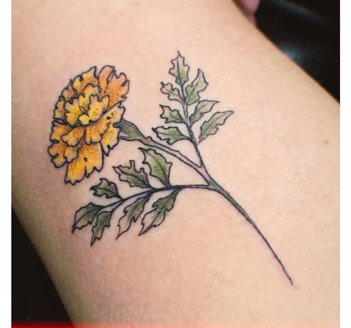 Marigold flower realism tattoo on the forearm by Jamie Clinton