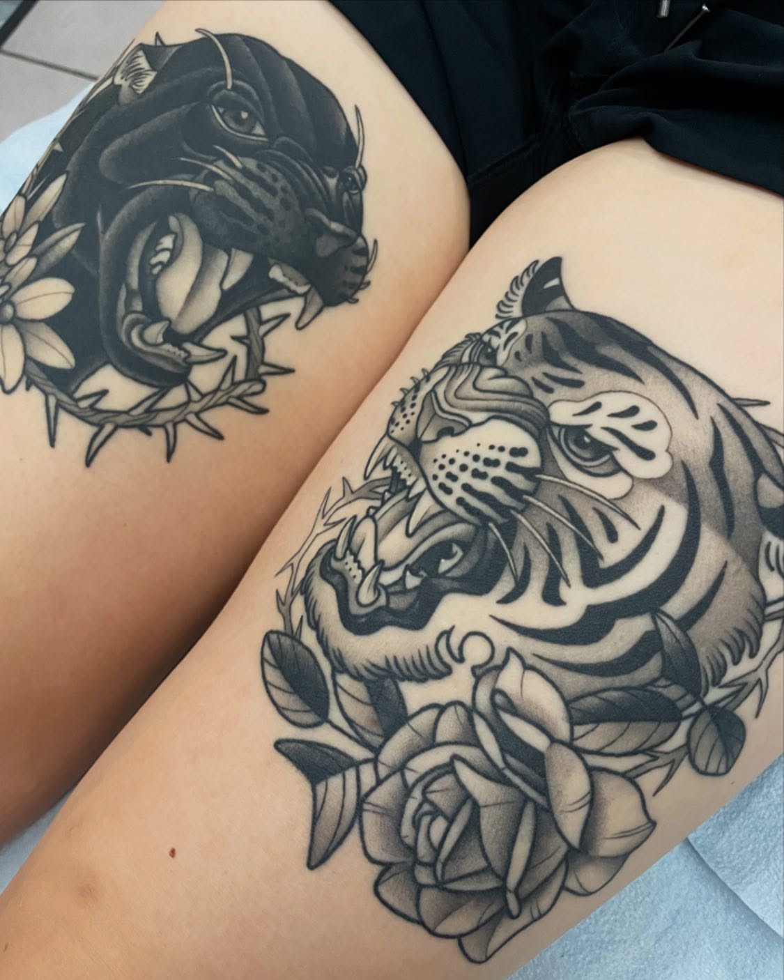 Tiger and roses realism tattoo on the thigh by Amy Jean, Minneapolis, Minnesota