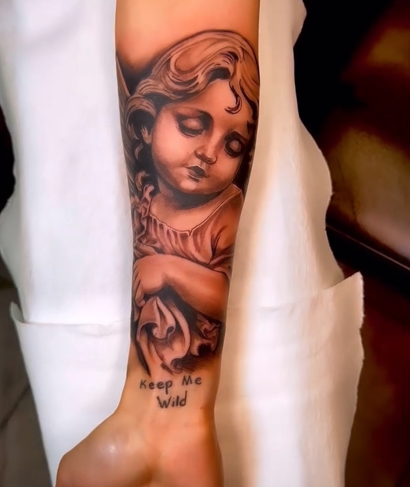 Child praying realism tattoo on the forearm by Greg Petrali