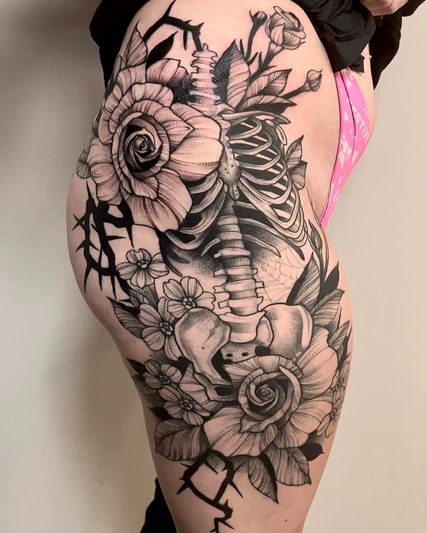 Skeleton with flowers realism tattoo on the thigh by Sterling Grice
