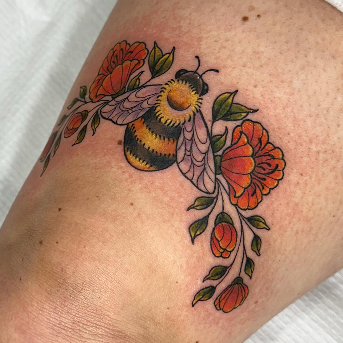 Bee and flowers American traditional tattoo on the upper arm by manda, Lebanon, Ohio