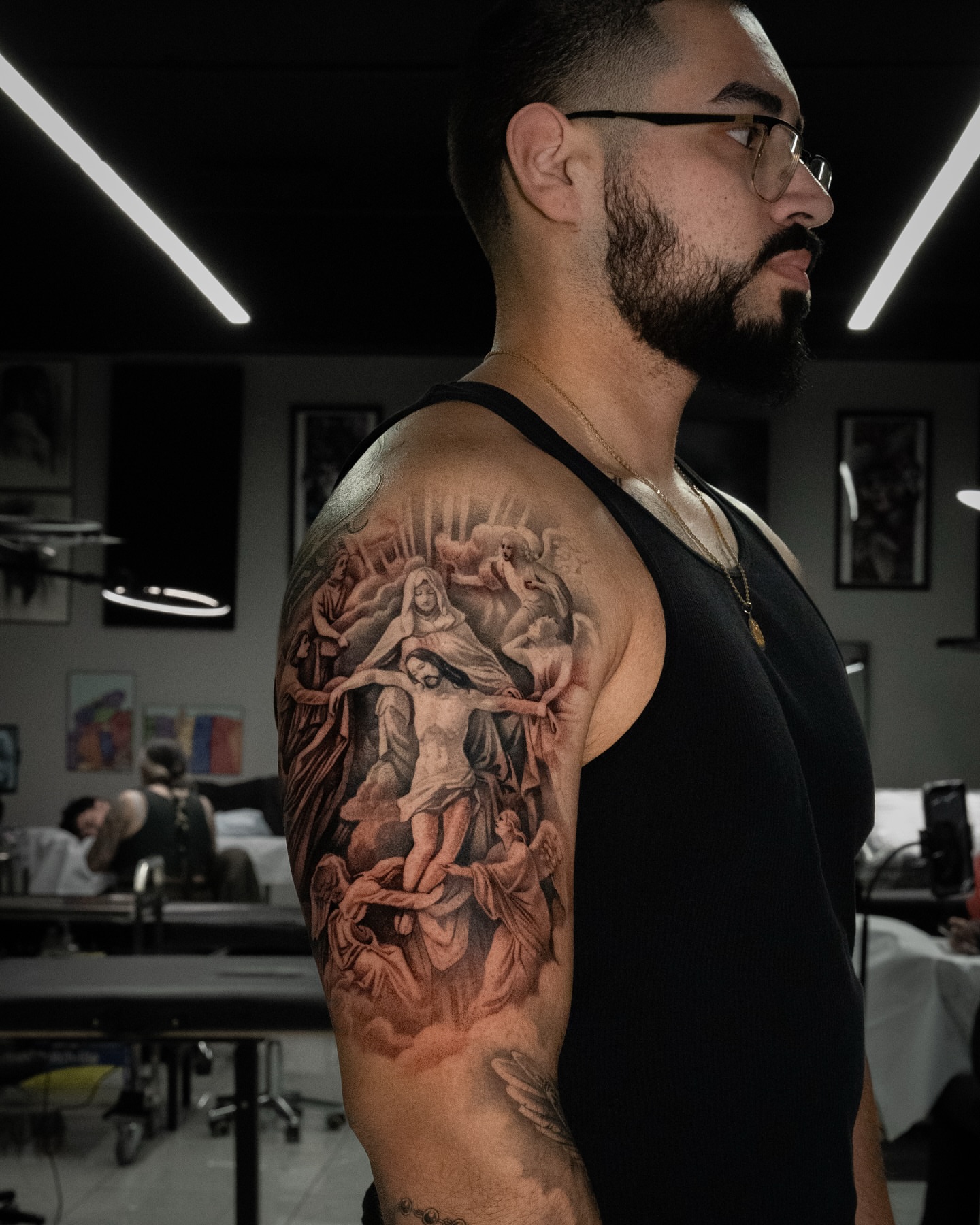 Religious scene realism tattoo on the upper arm by Joey Hella Tattoo Artist