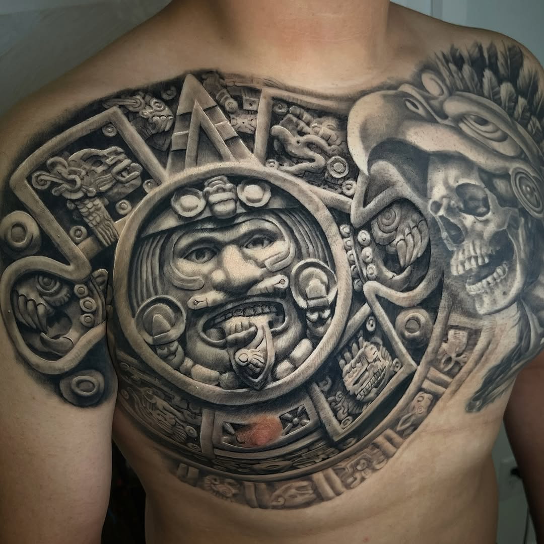 Aztec sun stone and skull surrealism tattoo on the chest by Claude Steven Estrada, Las Vegas, Nevada