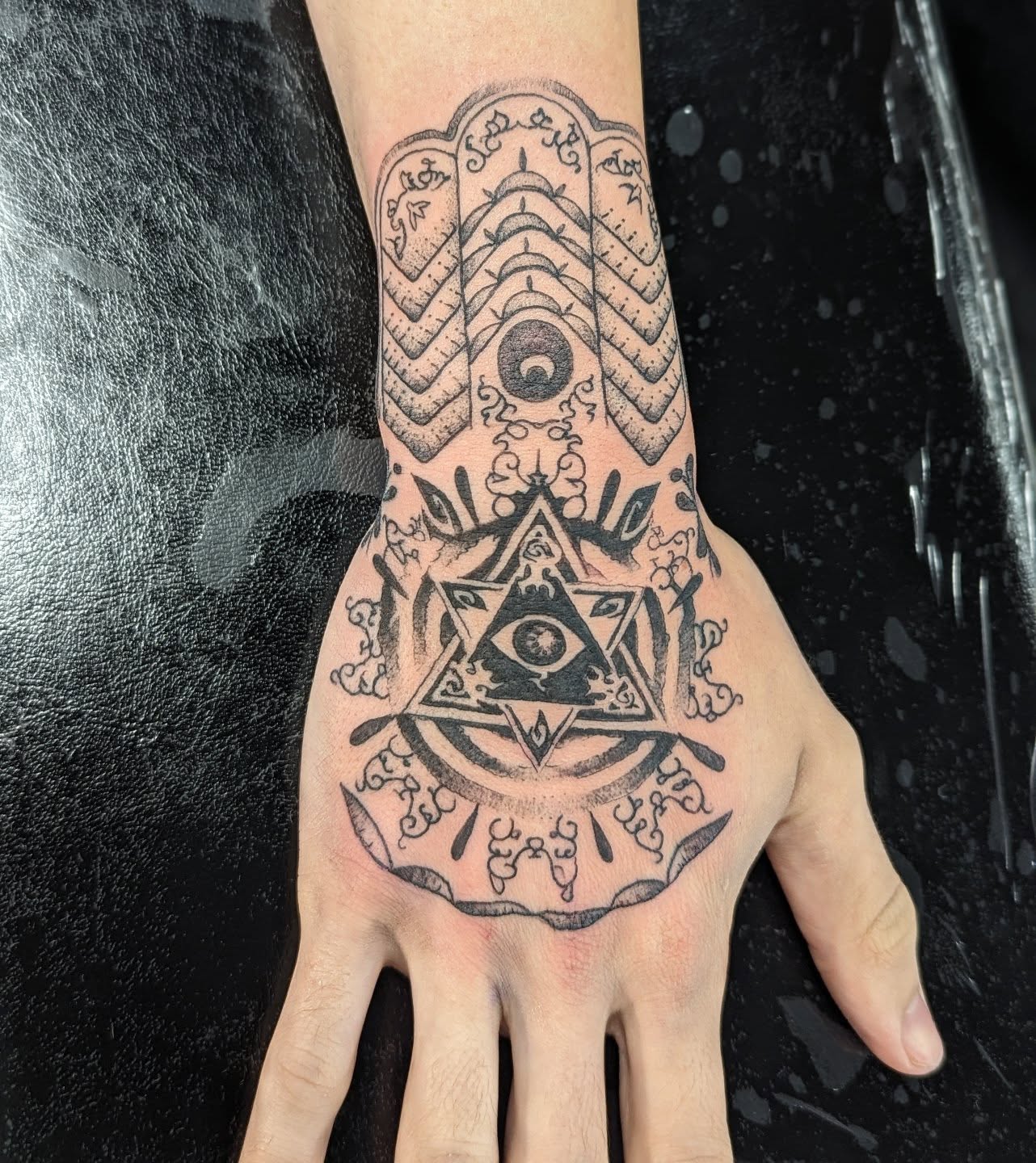 All-seeing eye within triangle geometric tattoo on the hand by DONEL 📍Denver