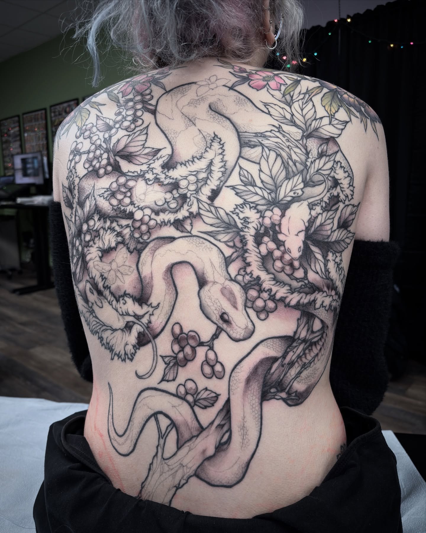 Snake and grapes realism tattoo on the back by Michael Langdale