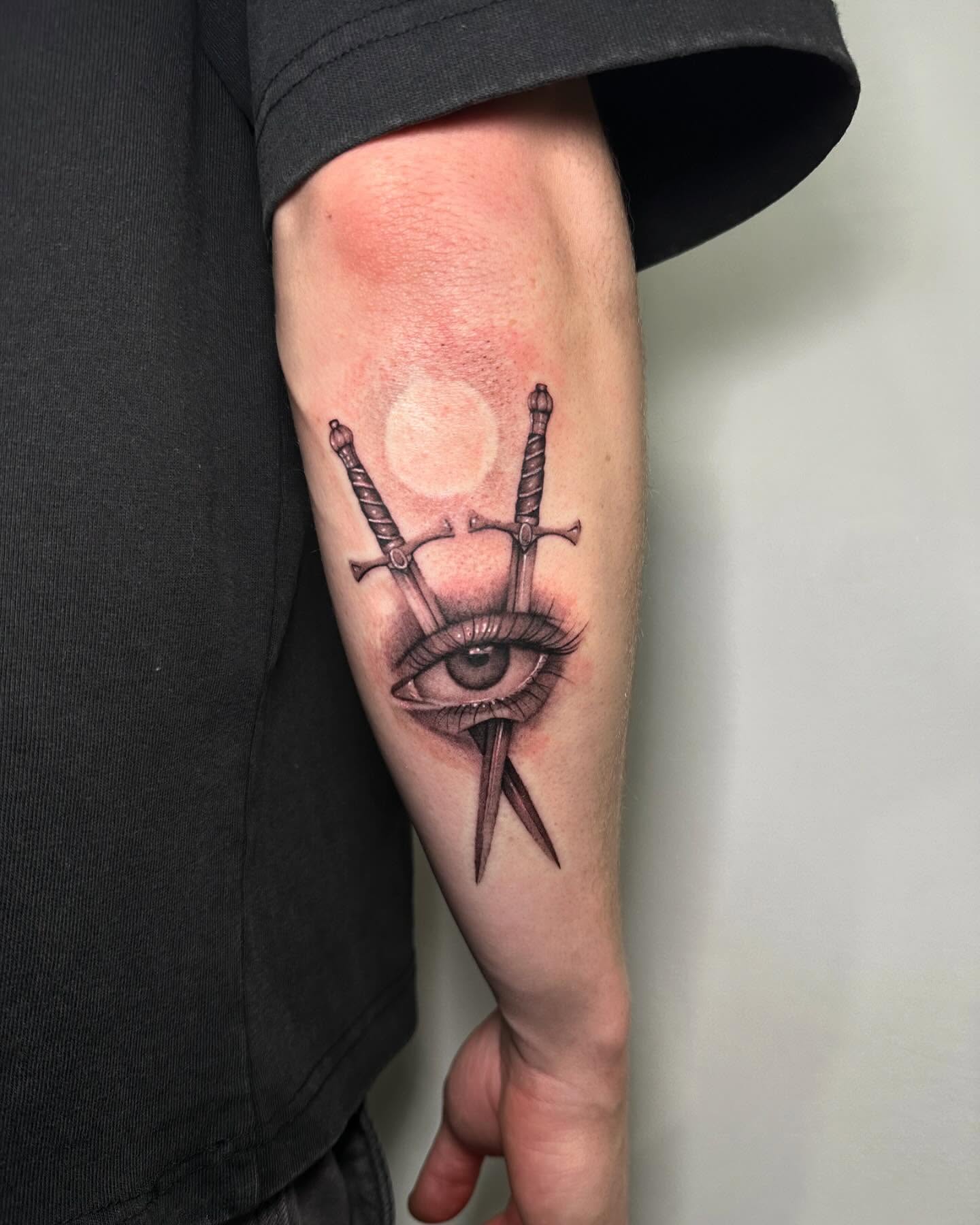 Eye with swords realism tattoo on the forearm by @piinkywabbiit, Roselle Park, New Jersey