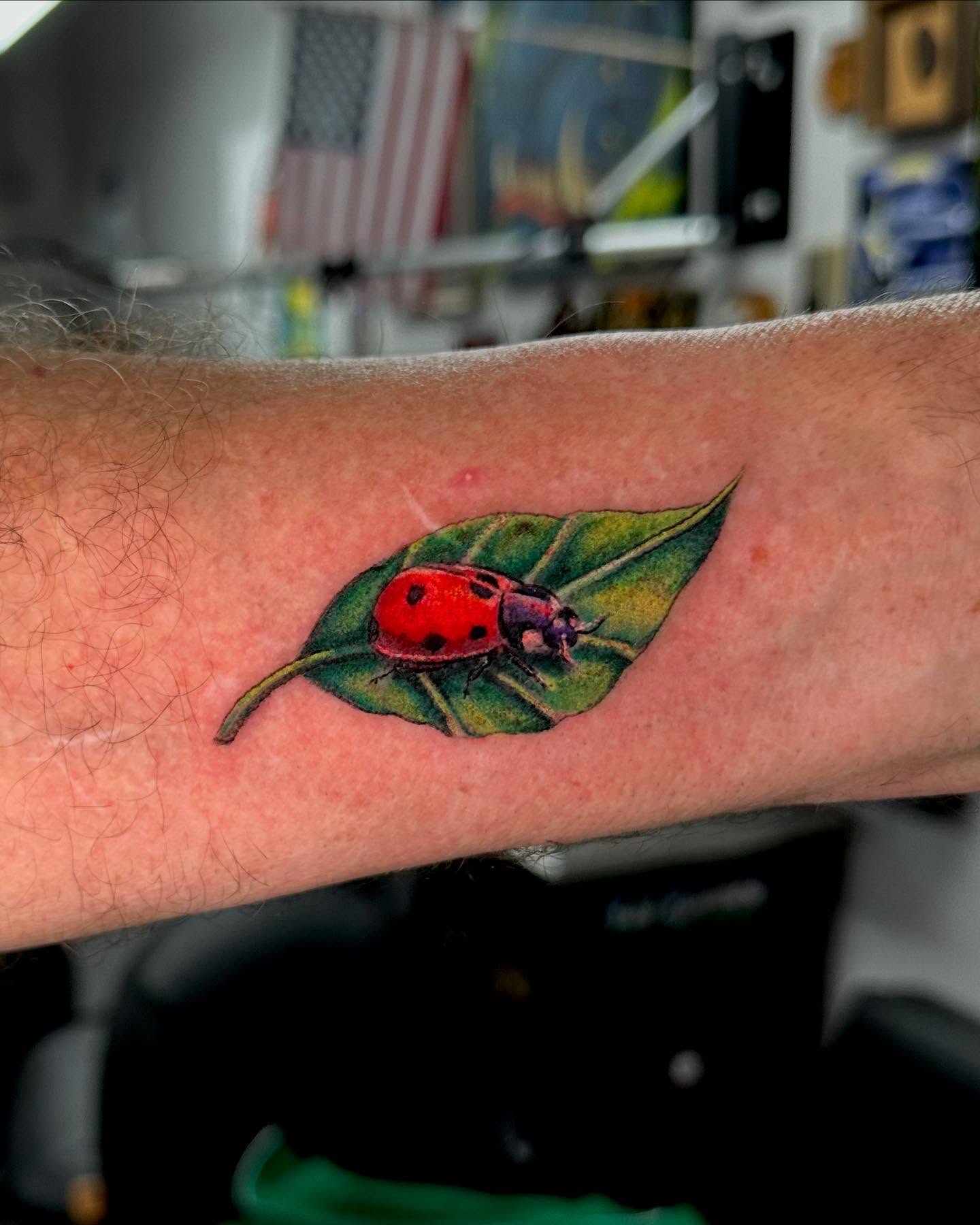 Ladybug on leaf realism tattoo on the forearm by MR