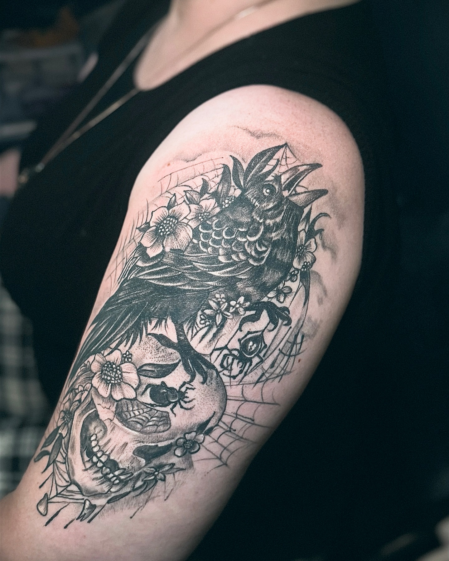 Skull and crow realism tattoo on the shoulder by Ken West
