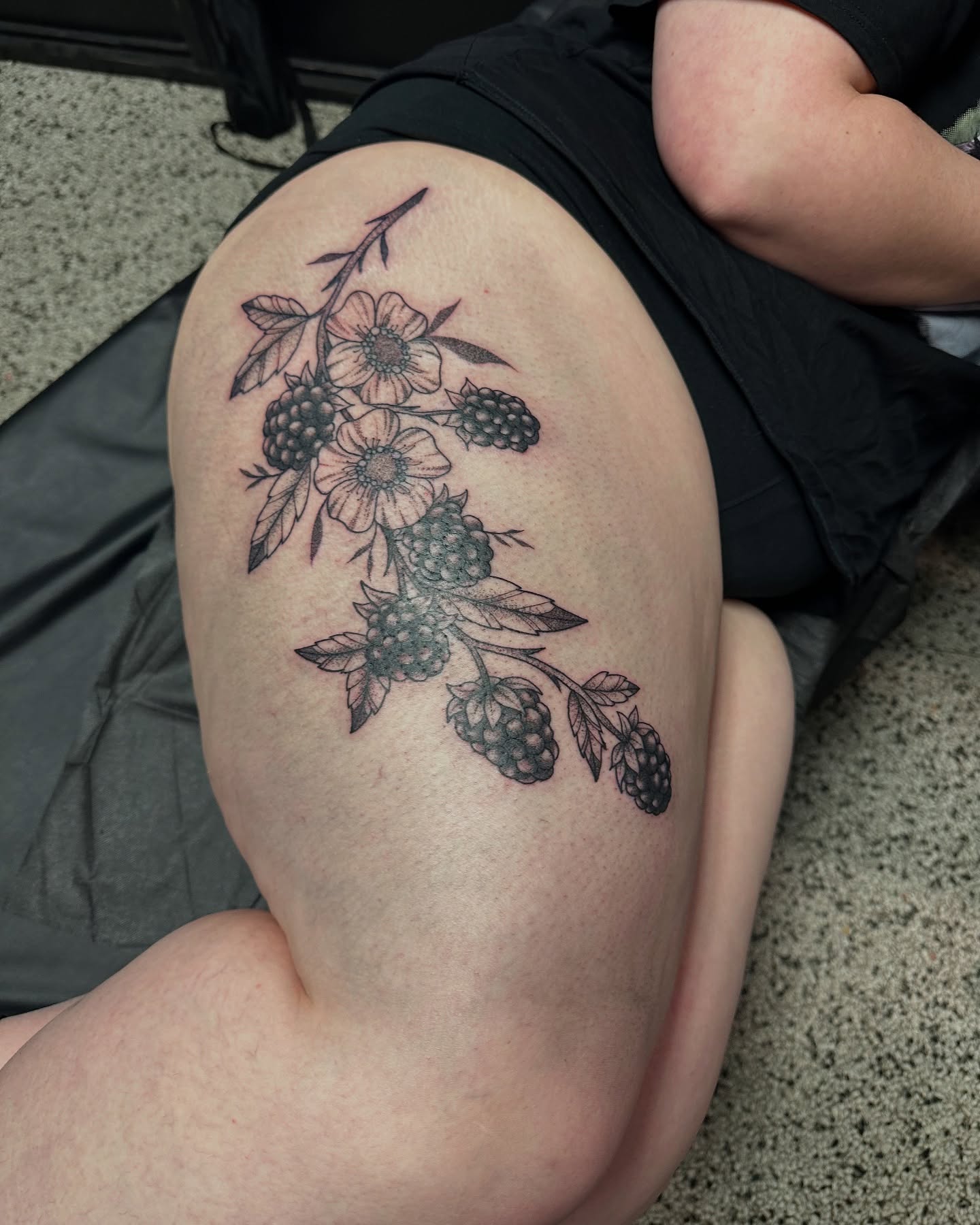 Flower and berries black and grey tattoo on the thigh by (Joshua) Van Cummings