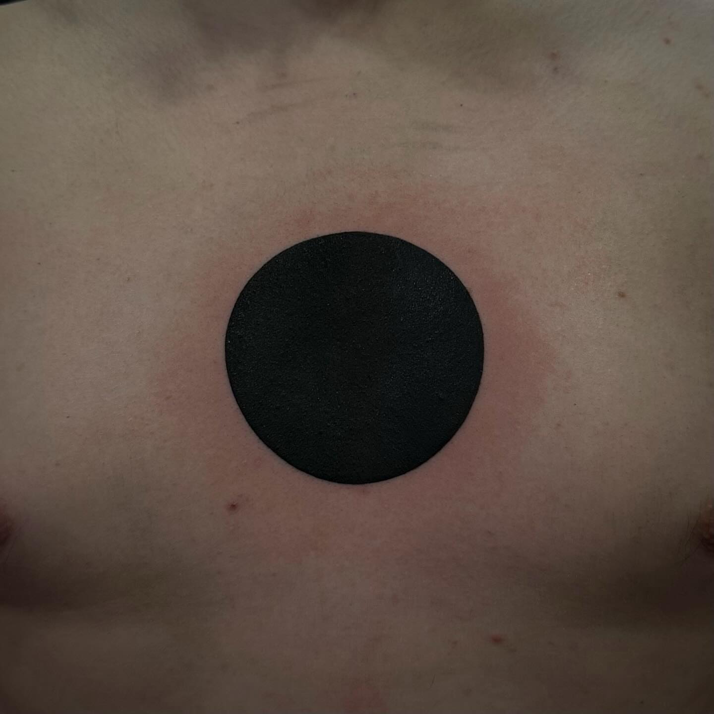 Circle black and grey tattoo on the chest by Emily‹𝟹