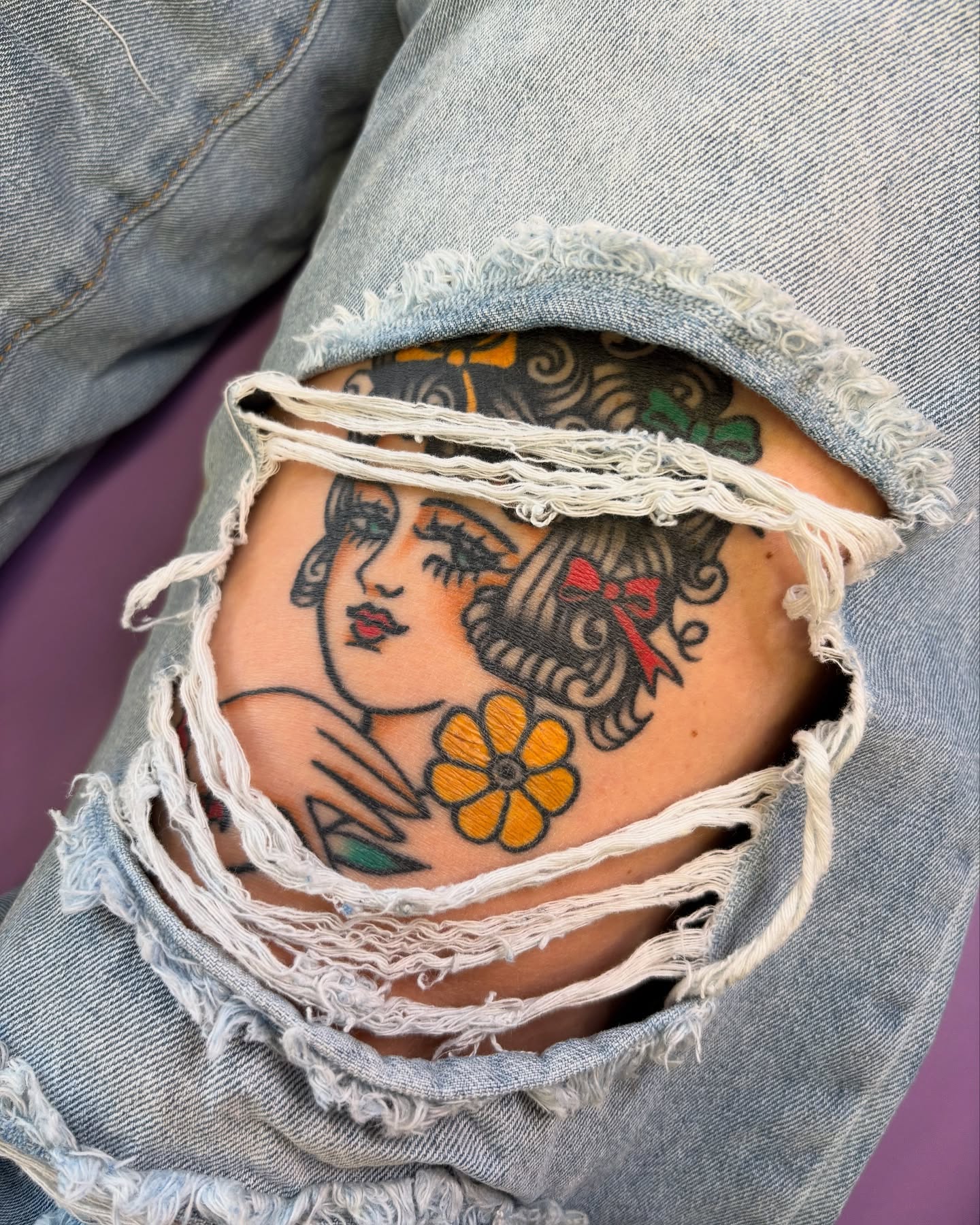 Flapper girl with flower American traditional tattoo on the thigh by Angie Isbell