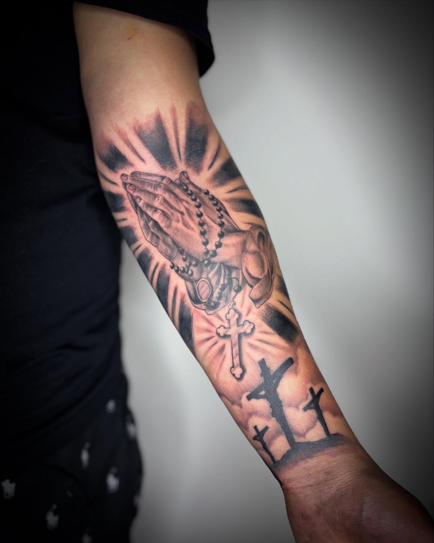 Praying hands with rosary black and grey tattoo on the forearm by Adrian Ram 🇬🇾🇵🇭
