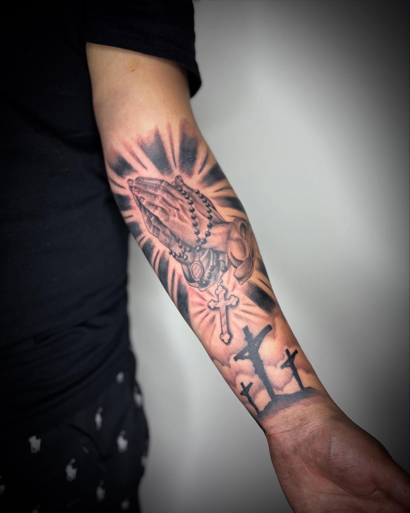 Praying hands with rosary black and grey tattoo on the forearm by Adrian Ram 🇬🇾🇵🇭