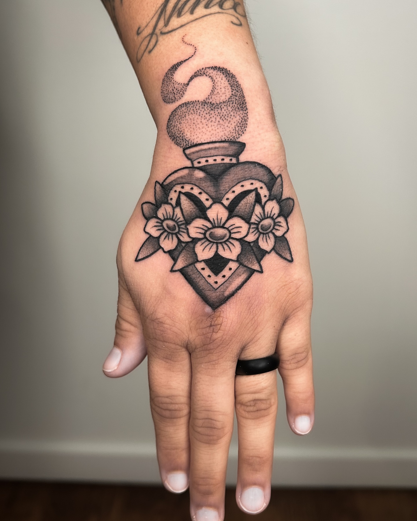 Perfume bottle with flowers dotwork tattoo on the hand by Crystal Thorns