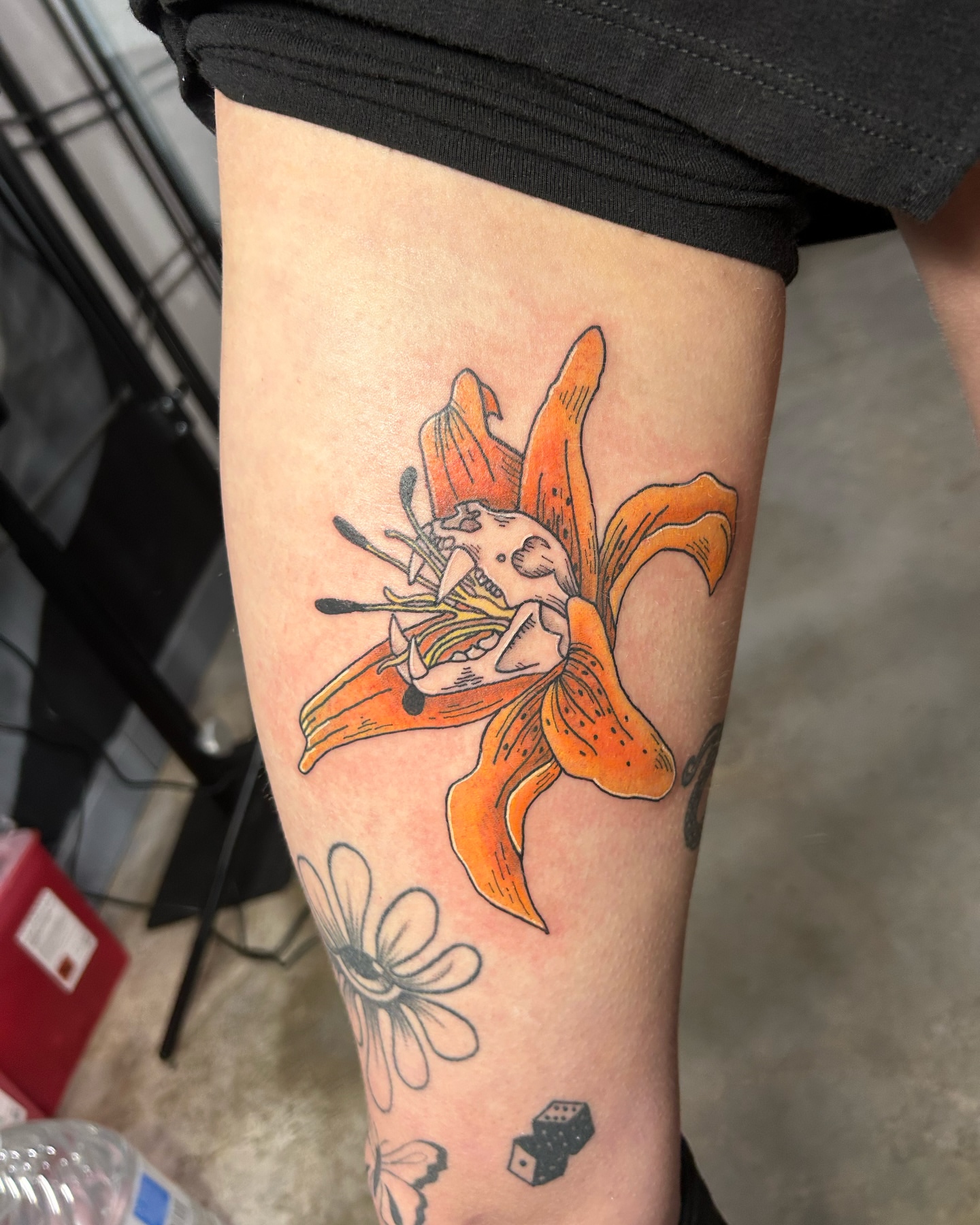 Lily with skull neo-traditional tattoo on the thigh by goose 🪿