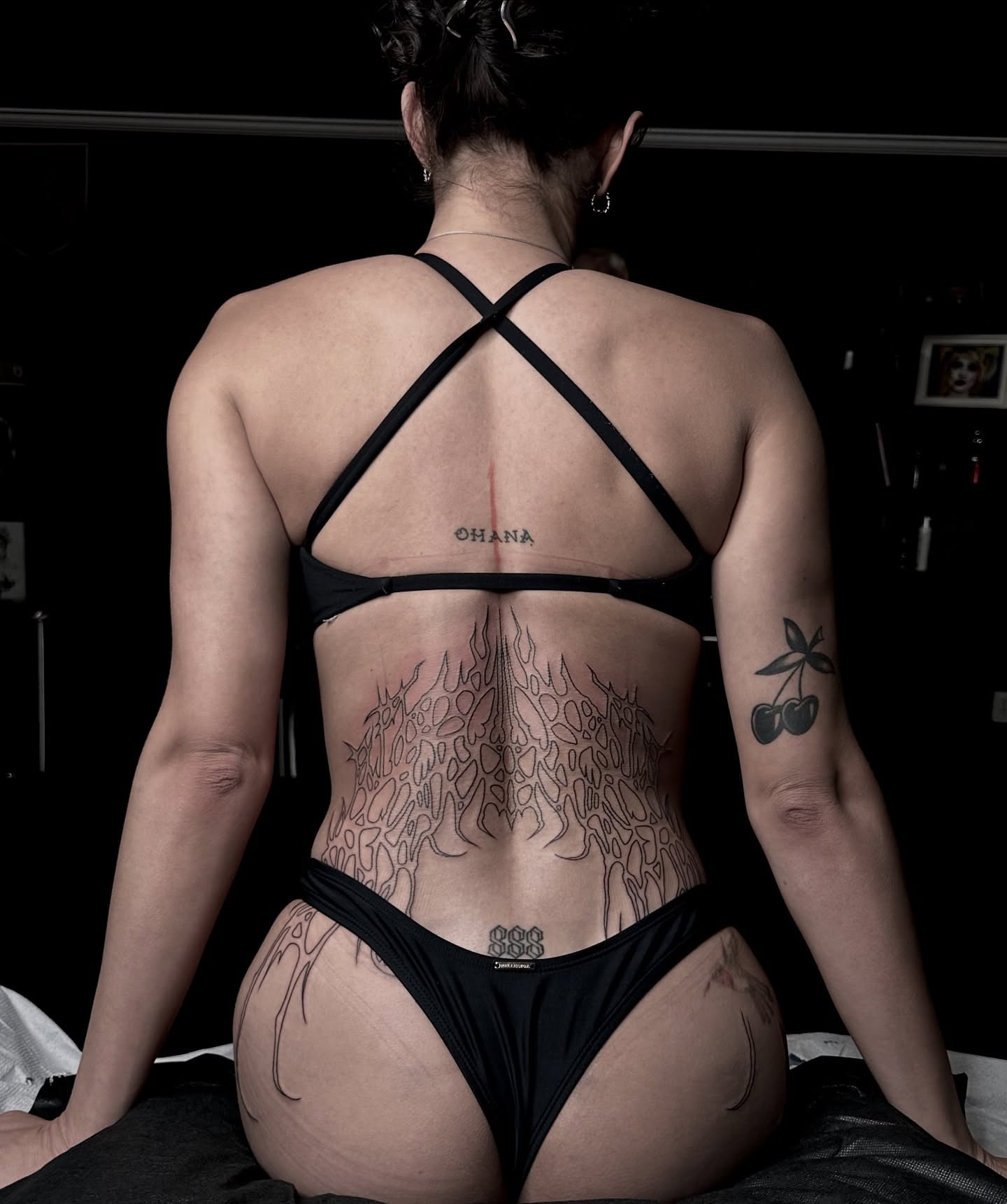 Flames black and grey tattoo on the back by Emersyn DeLuna