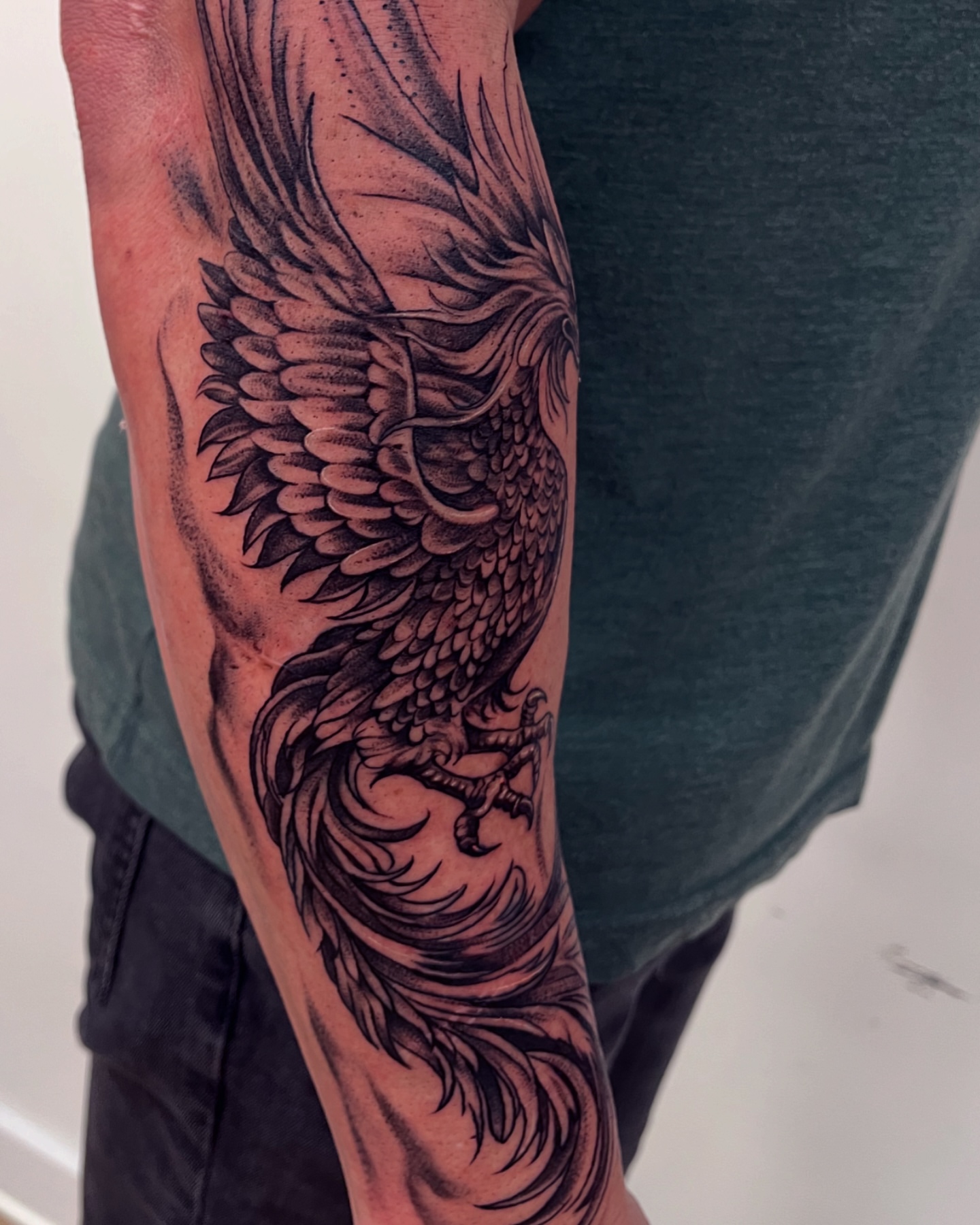 Phoenix black and grey tattoo on the forearm by Claire Litsey