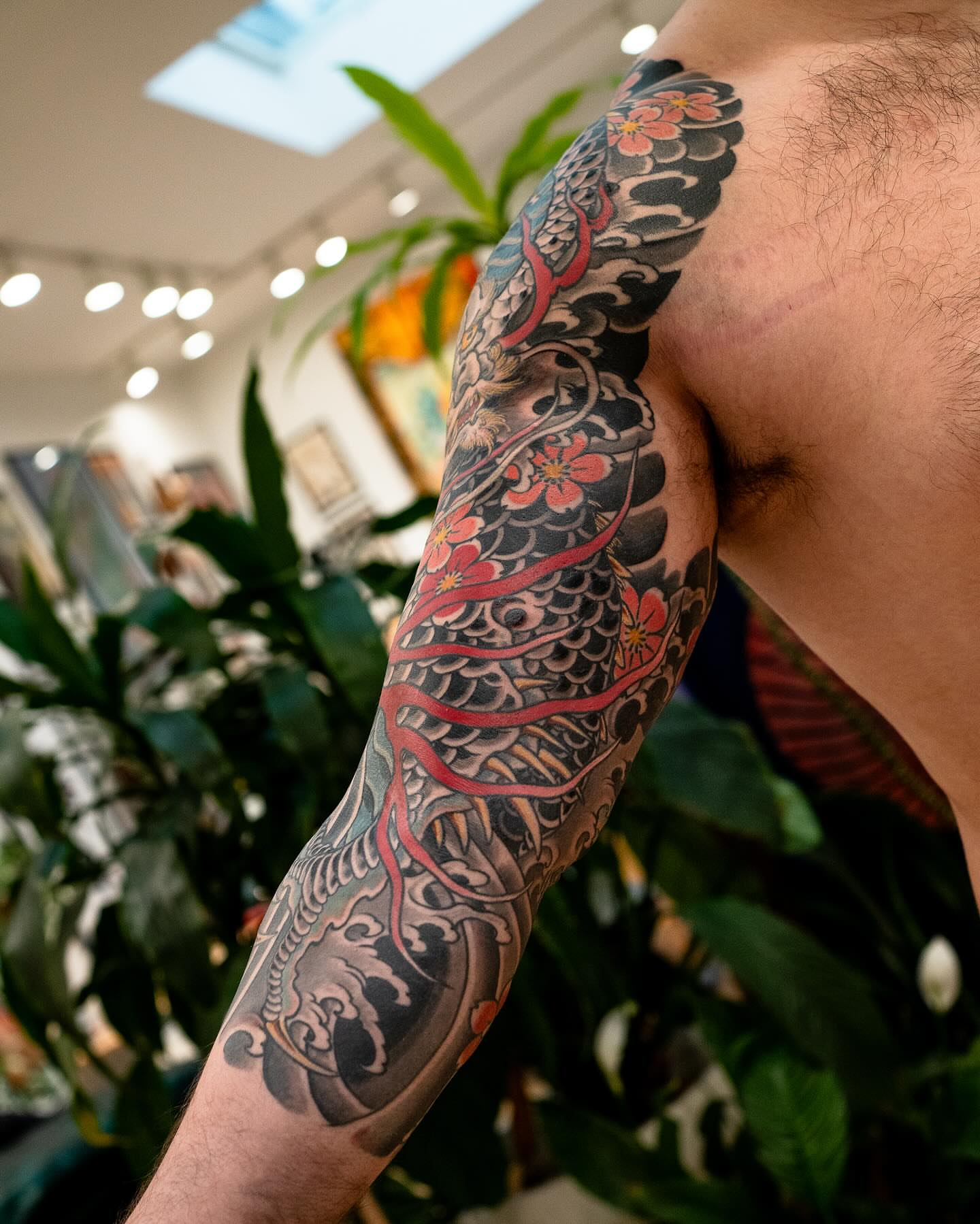 Fish and flowers japanese irezumi tattoo on the upper arm by Matt Leibo, San Francisco, California