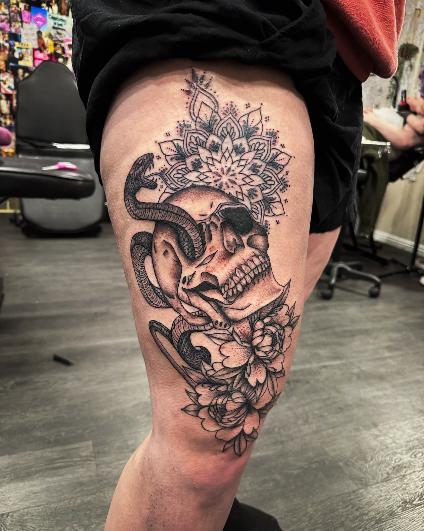 Skull with snake and flowers realism tattoo on the thigh by @inkspirationtattoo_co