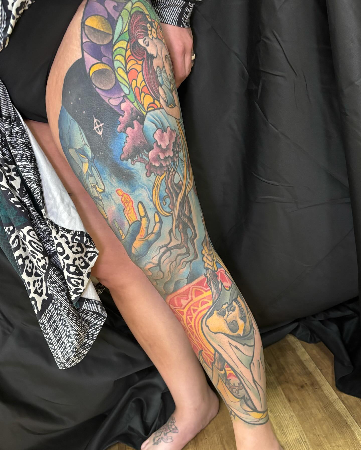 Astronaut and cosmic landscape surrealism tattoo on the forearm by Rene Chavira