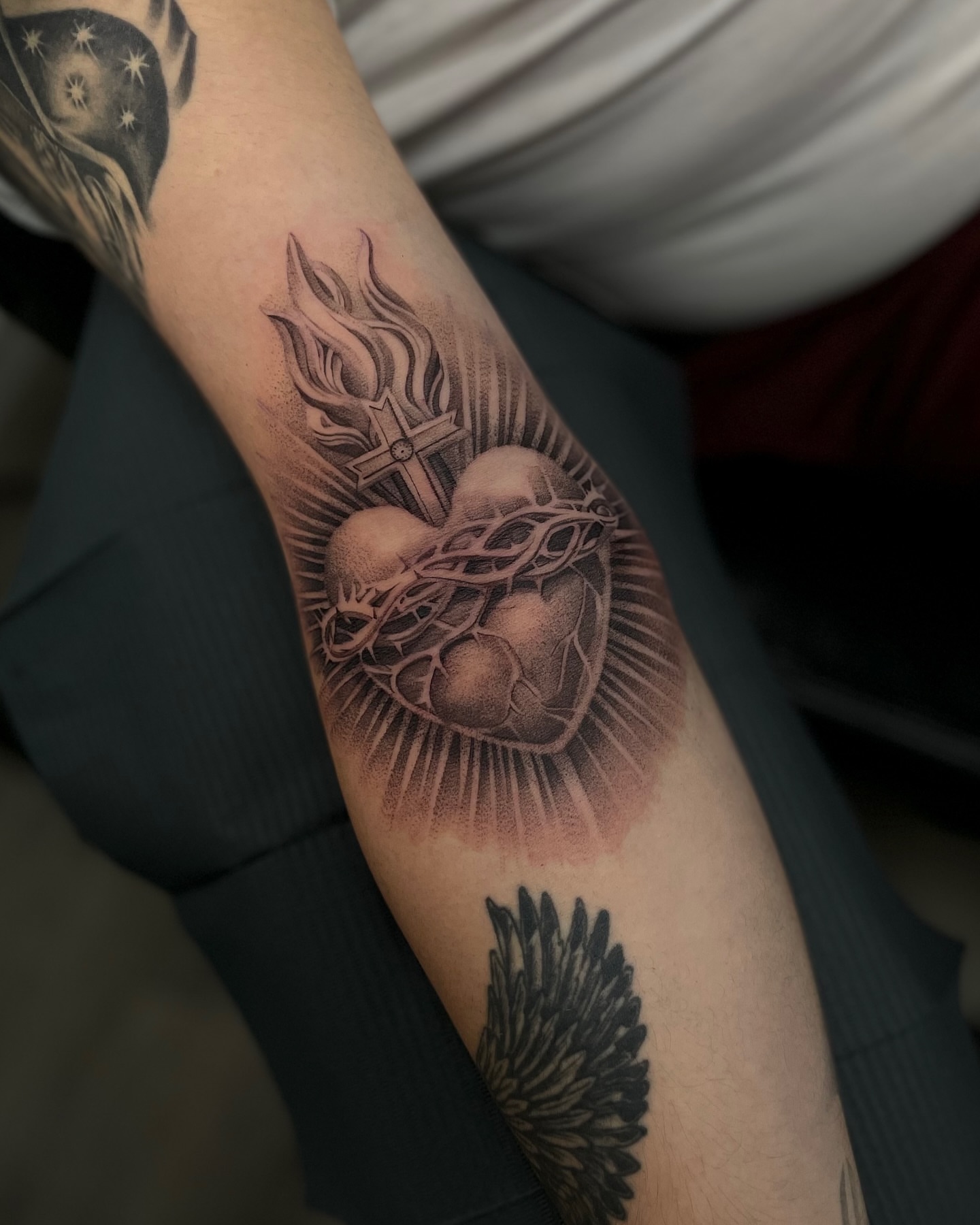 Heart with cross dotwork tattoo on the forearm by Vanessa Valdivia
