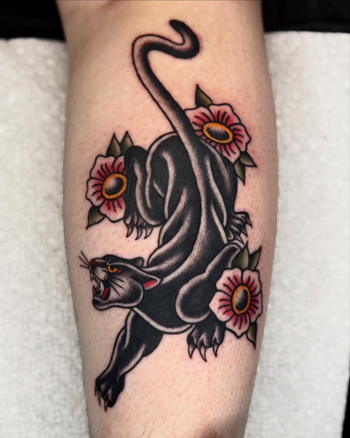 Panther and flowers American traditional tattoo on the forearm by Meg Nefcy, Milford, Michigan