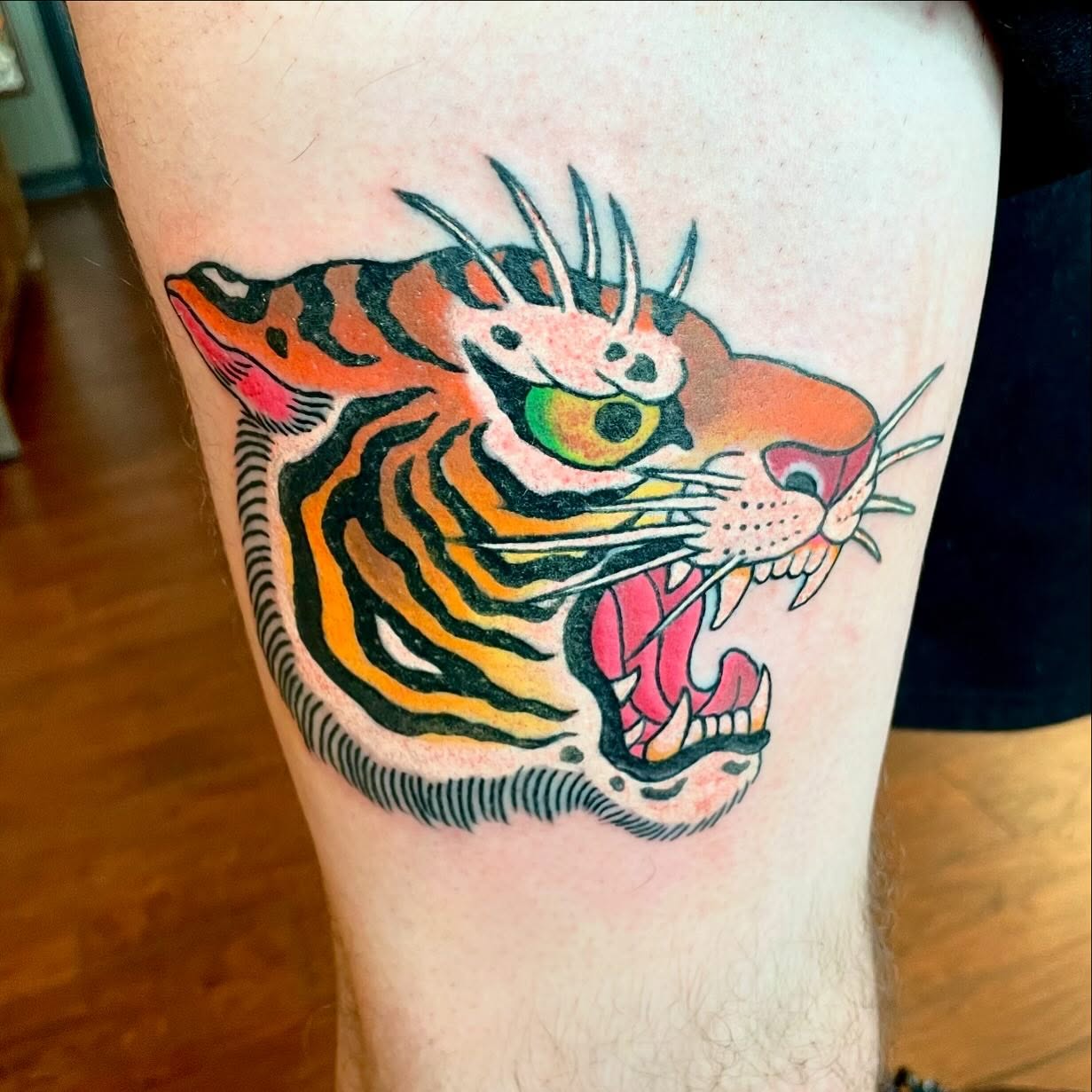 Tiger American traditional tattoo on the thigh by Seth Griffin