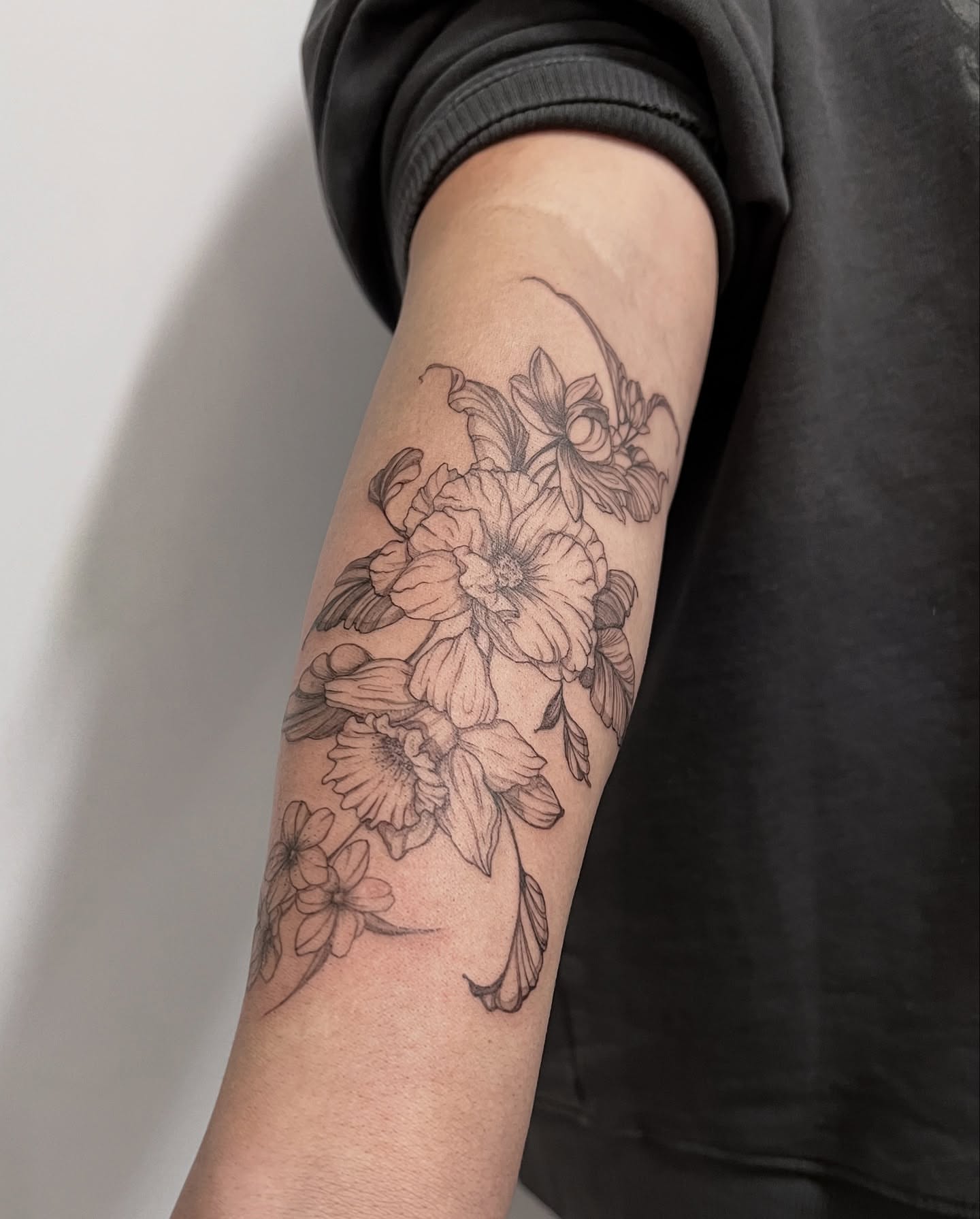 Floral bouquet black and grey tattoo on the forearm by Seraphim
