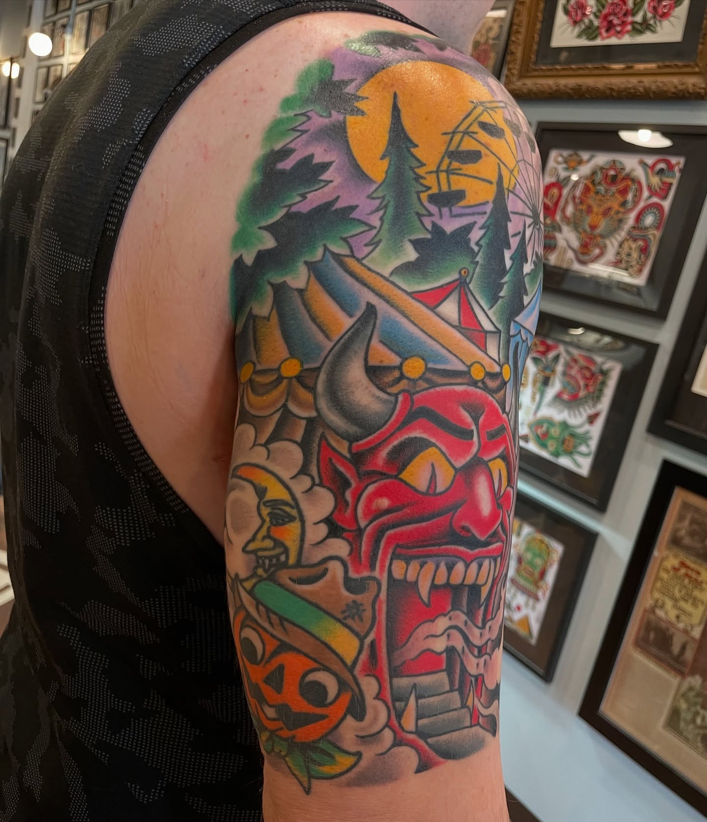 Circus tent and devil American traditional tattoo on the upper arm by Grandma Approved, Chicago, Illinois