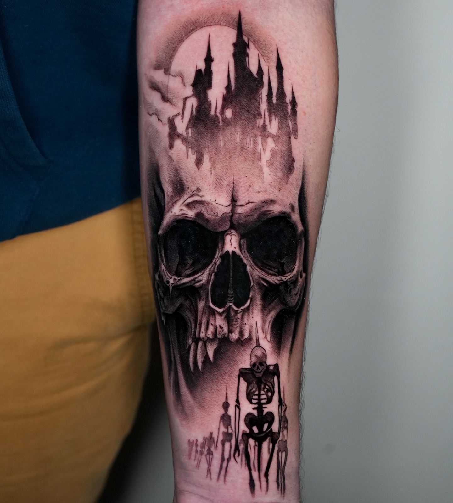 Skull and castle dark realism tattoo on the forearm by Jesse Reip, Lakewood, Ohio