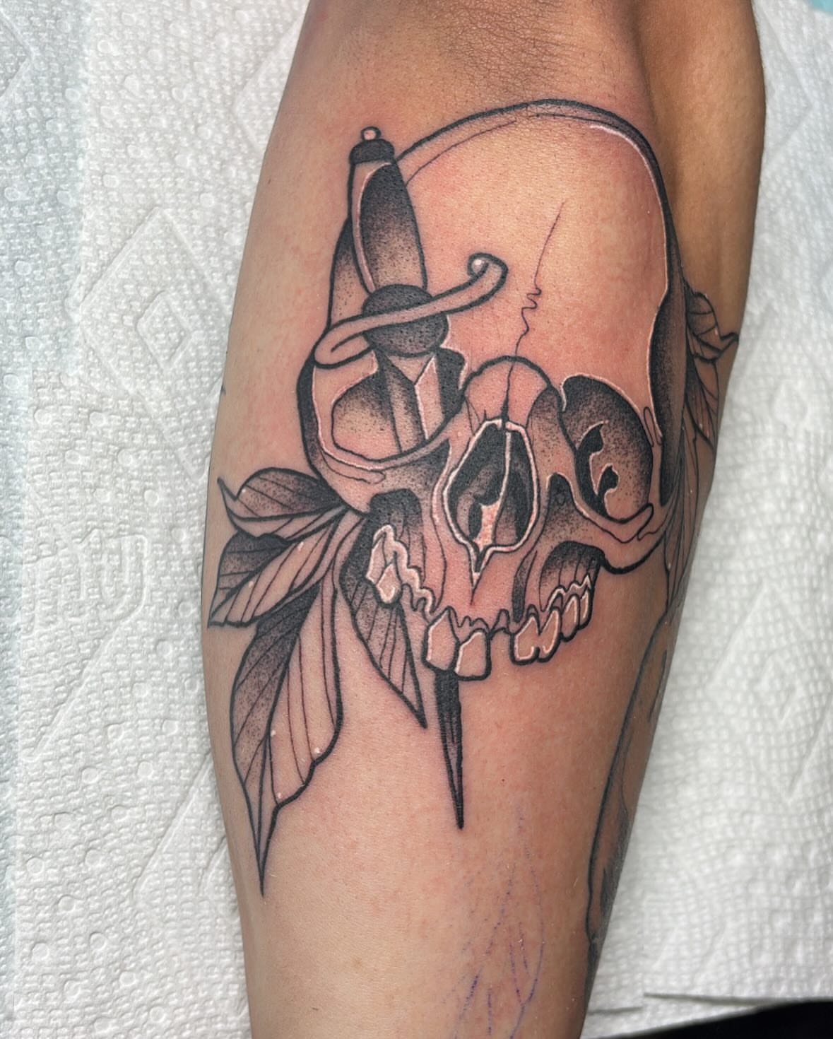 Skull with dagger realism tattoo on the forearm by Edward A. Boesch