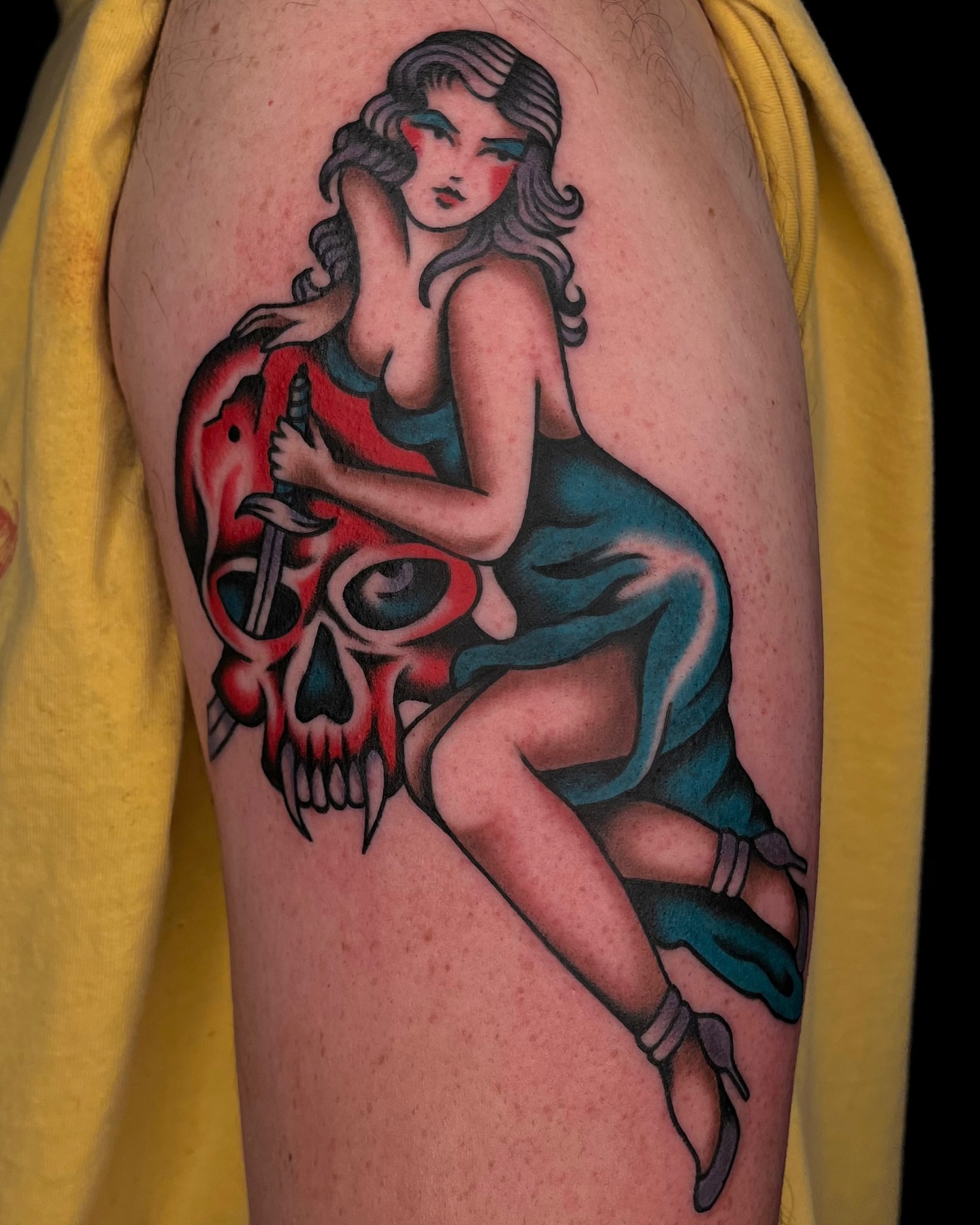 Woman with skull American traditional tattoo on the thigh by kate