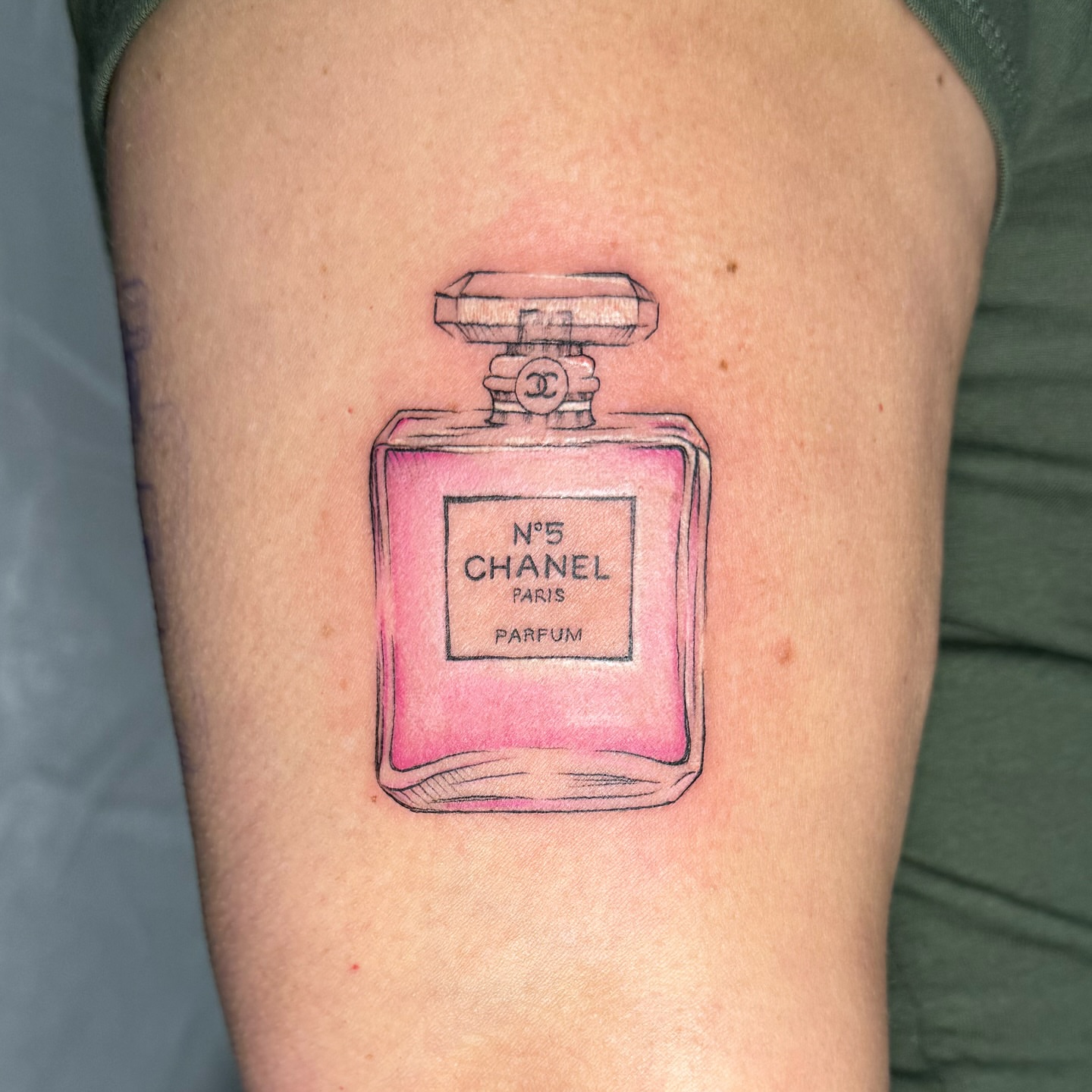 Chanel No. 5 perfume bottle realism tattoo on the thigh by RyAnn Lynn