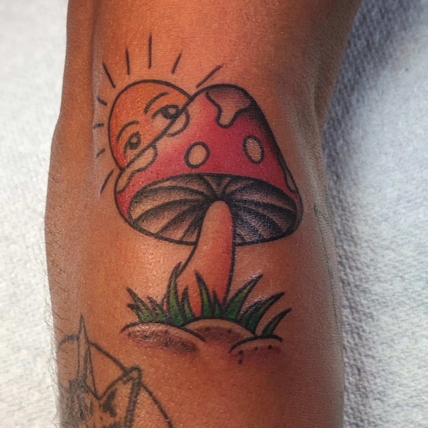 Mushroom with face trash polka tattoo on the forearm by Matt Simmonds