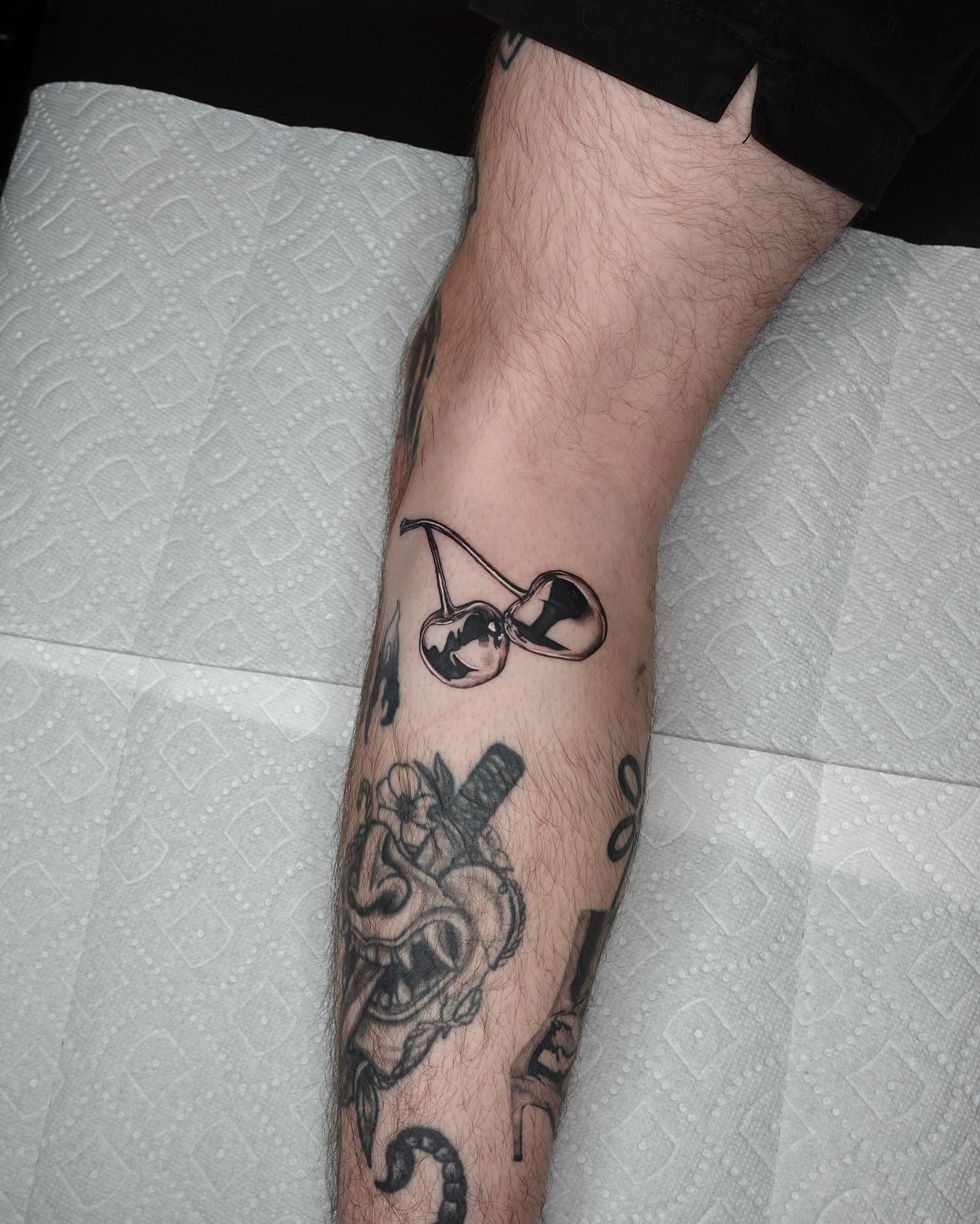 Cherry black and grey tattoo on the forearm by Tat by Brendan
