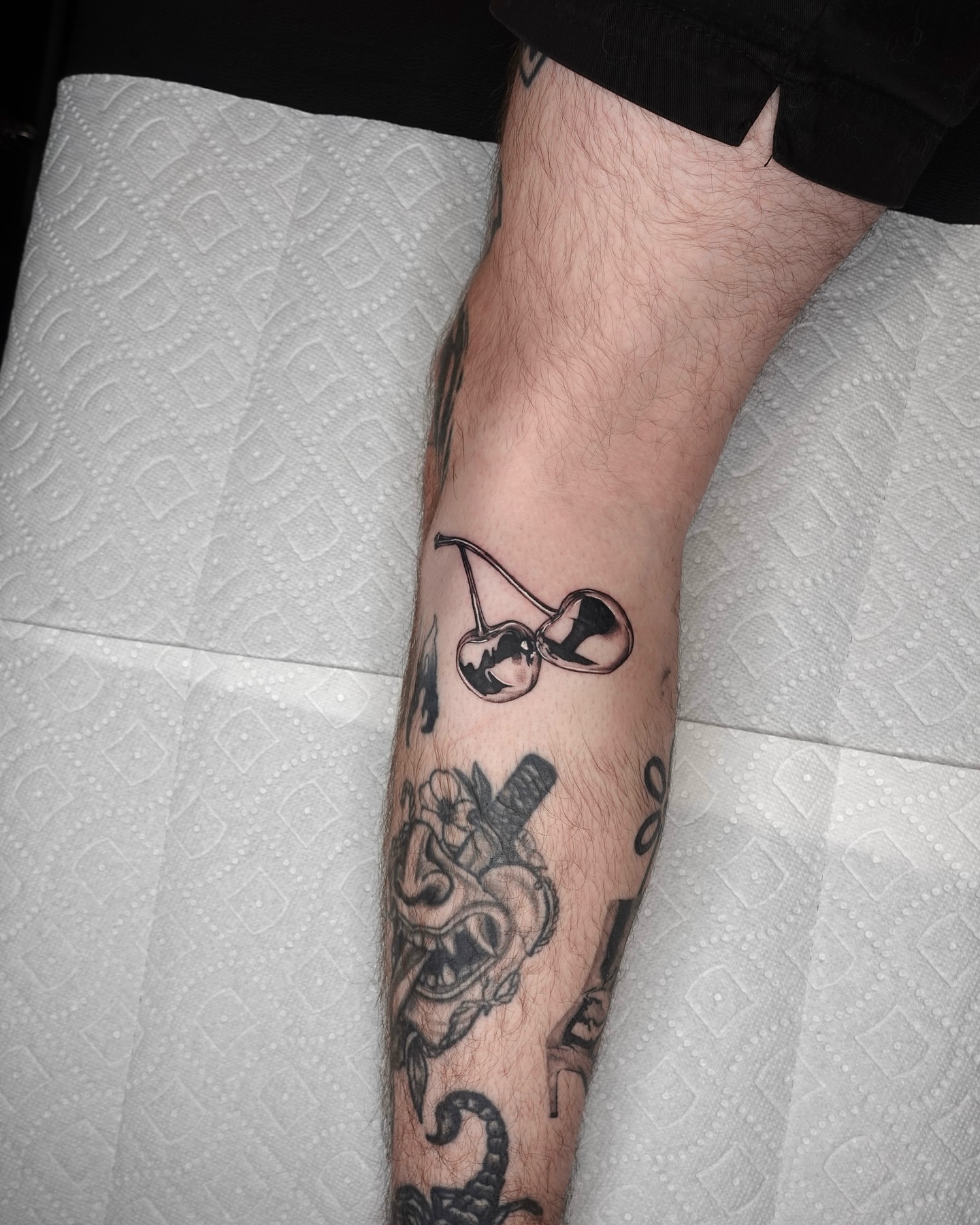 Cherry black and grey tattoo on the forearm by Tat by Brendan