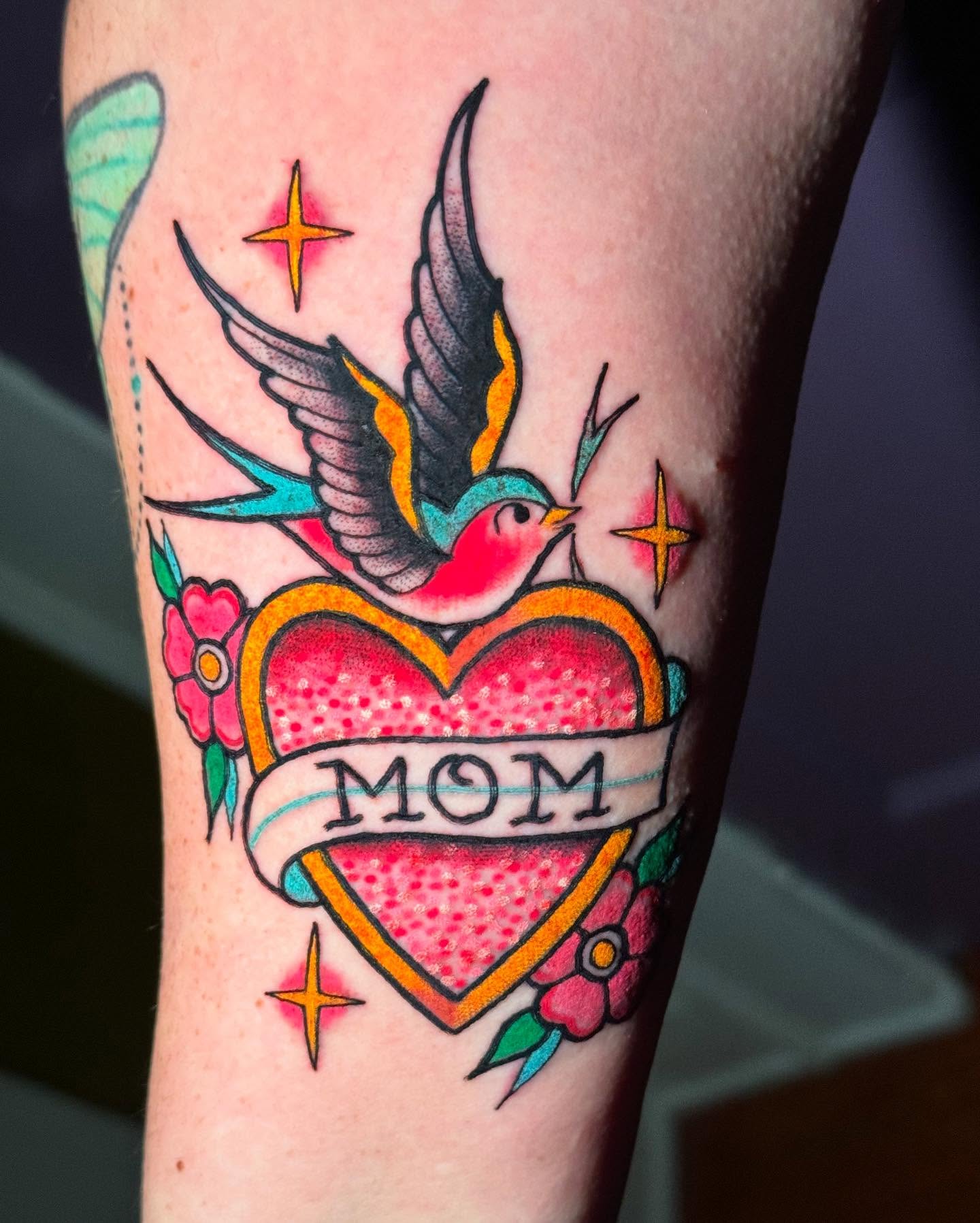 Swallow and heart American traditional tattoo on the forearm by Chelsea Lane