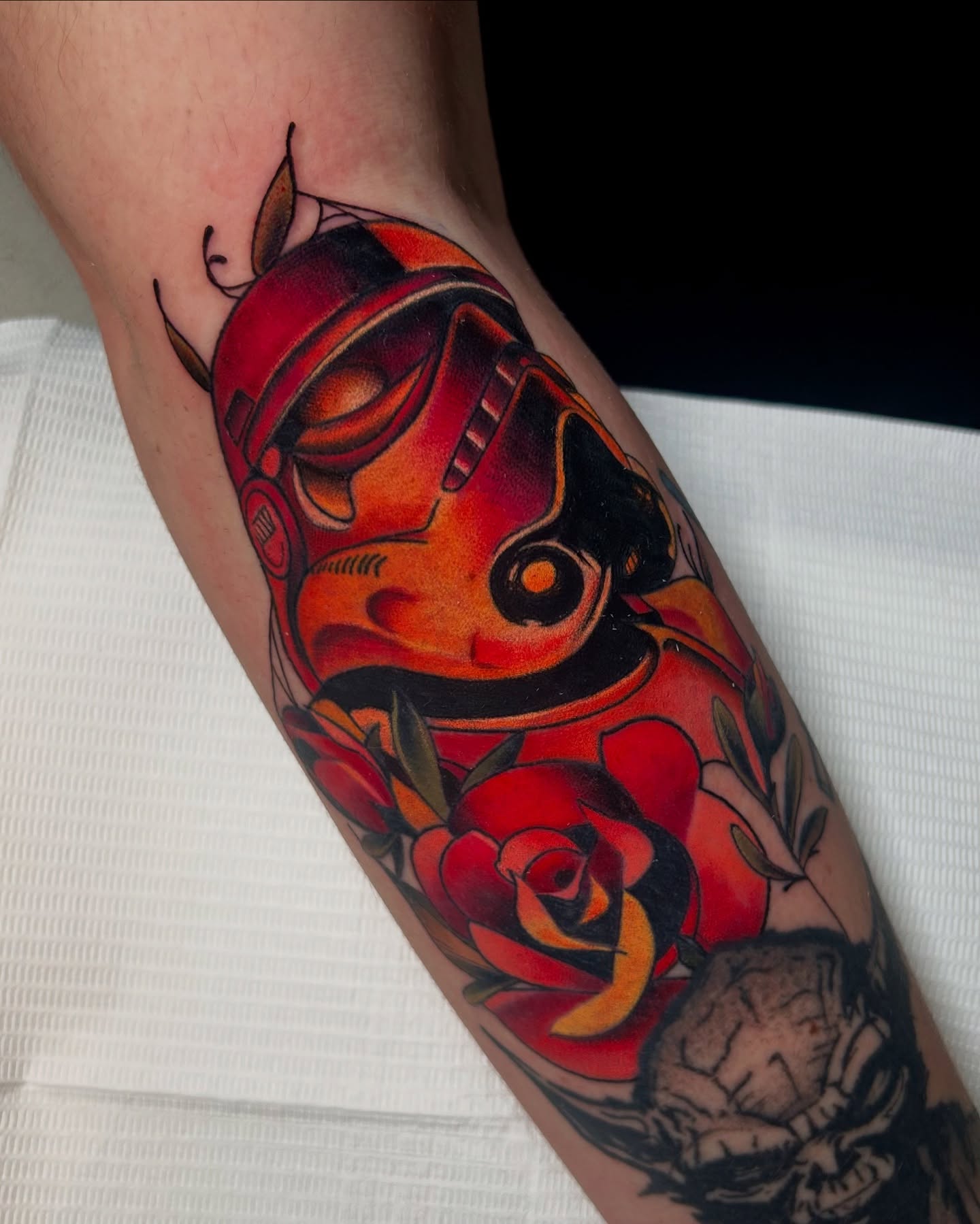 Stormtrooper helmet and roses American traditional tattoo on the forearm by Tattoos By Lola Cavotta, Willoughby, Ohio