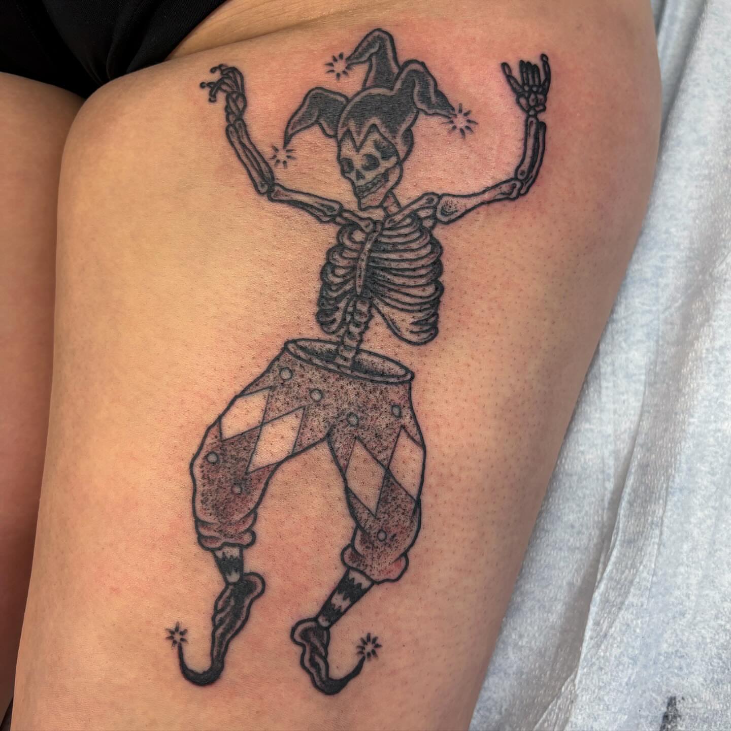 Jester skeleton dotwork tattoo on the thigh by Brandi ⛓, Detroit, Michigan