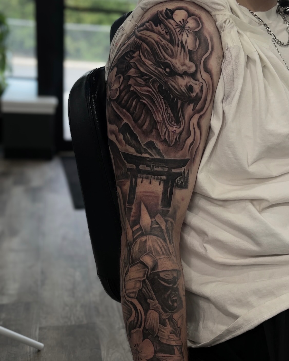 Dragon and samurai realism tattoo on the upper arm by Morrison Vo