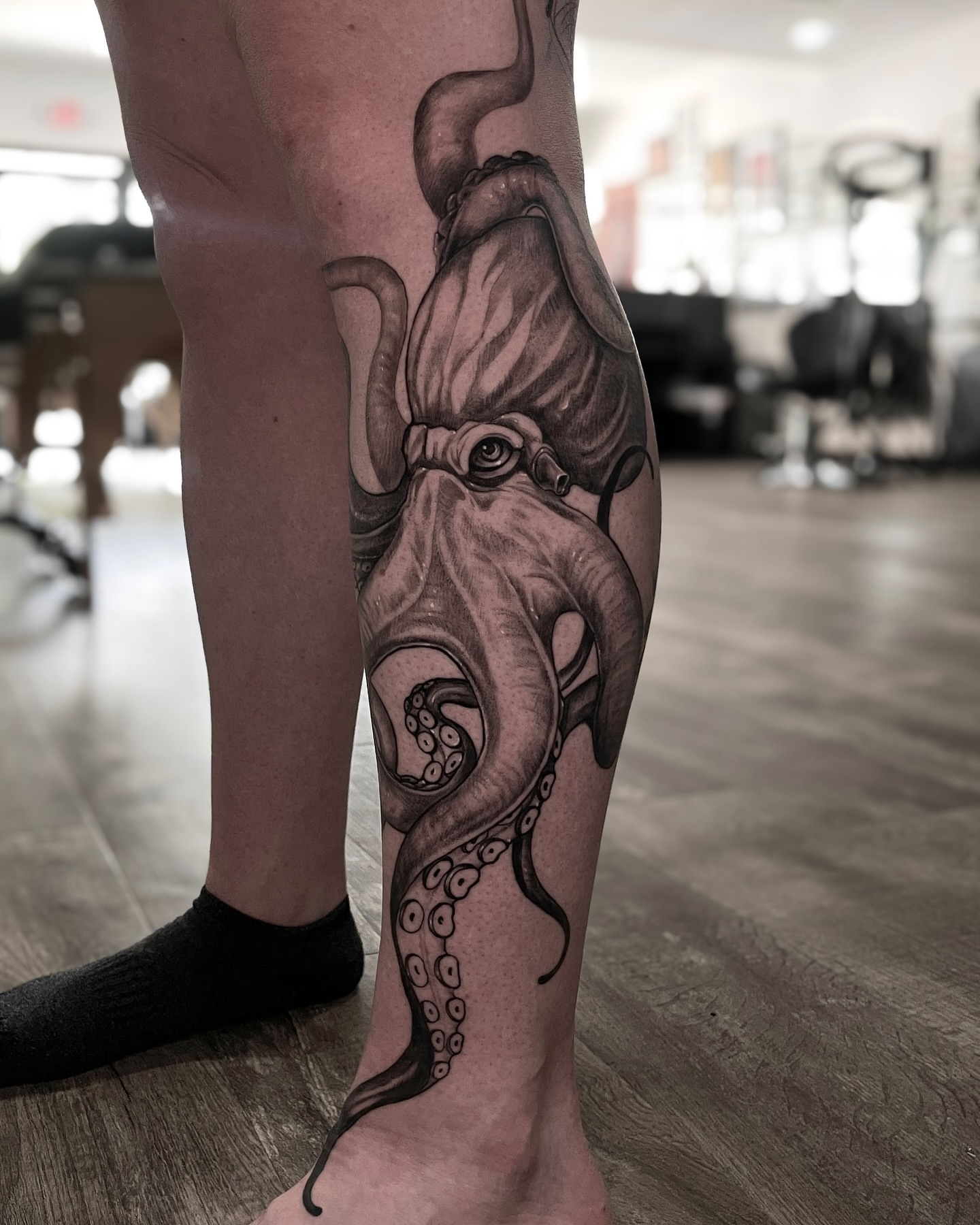 Octopus realism tattoo on the calf by Morrison Vo